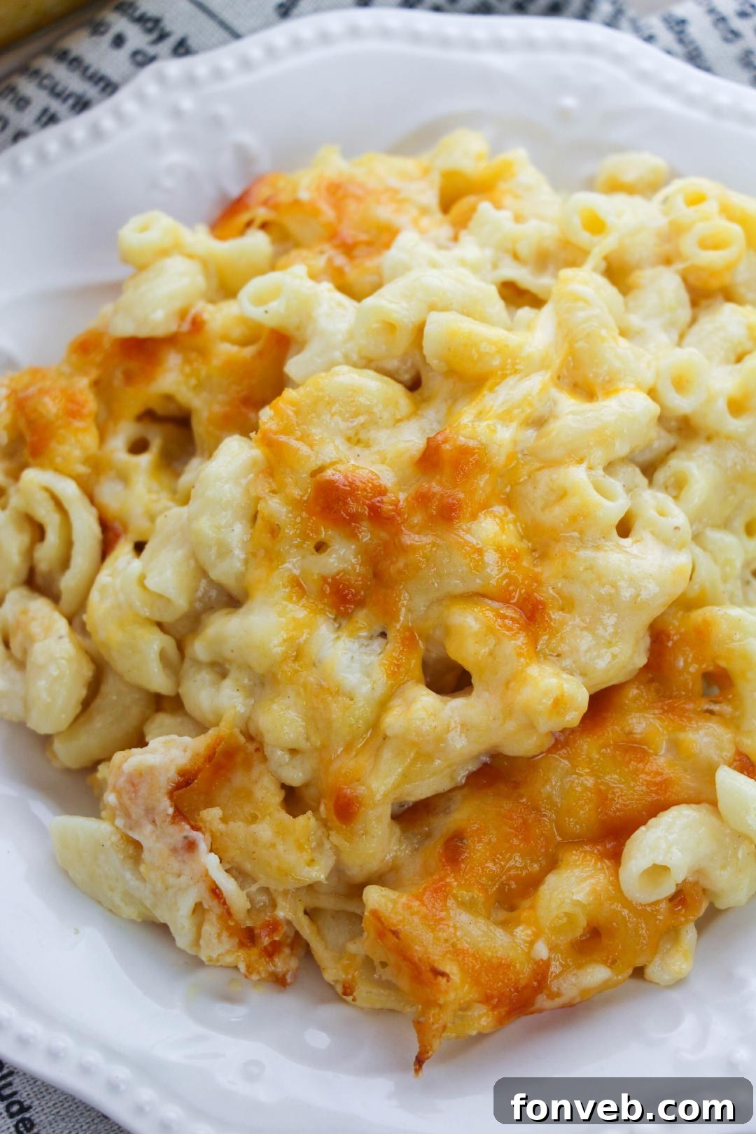 Close-up of a golden-brown baked macaroni and cheese in a casserole dish, ready to be served