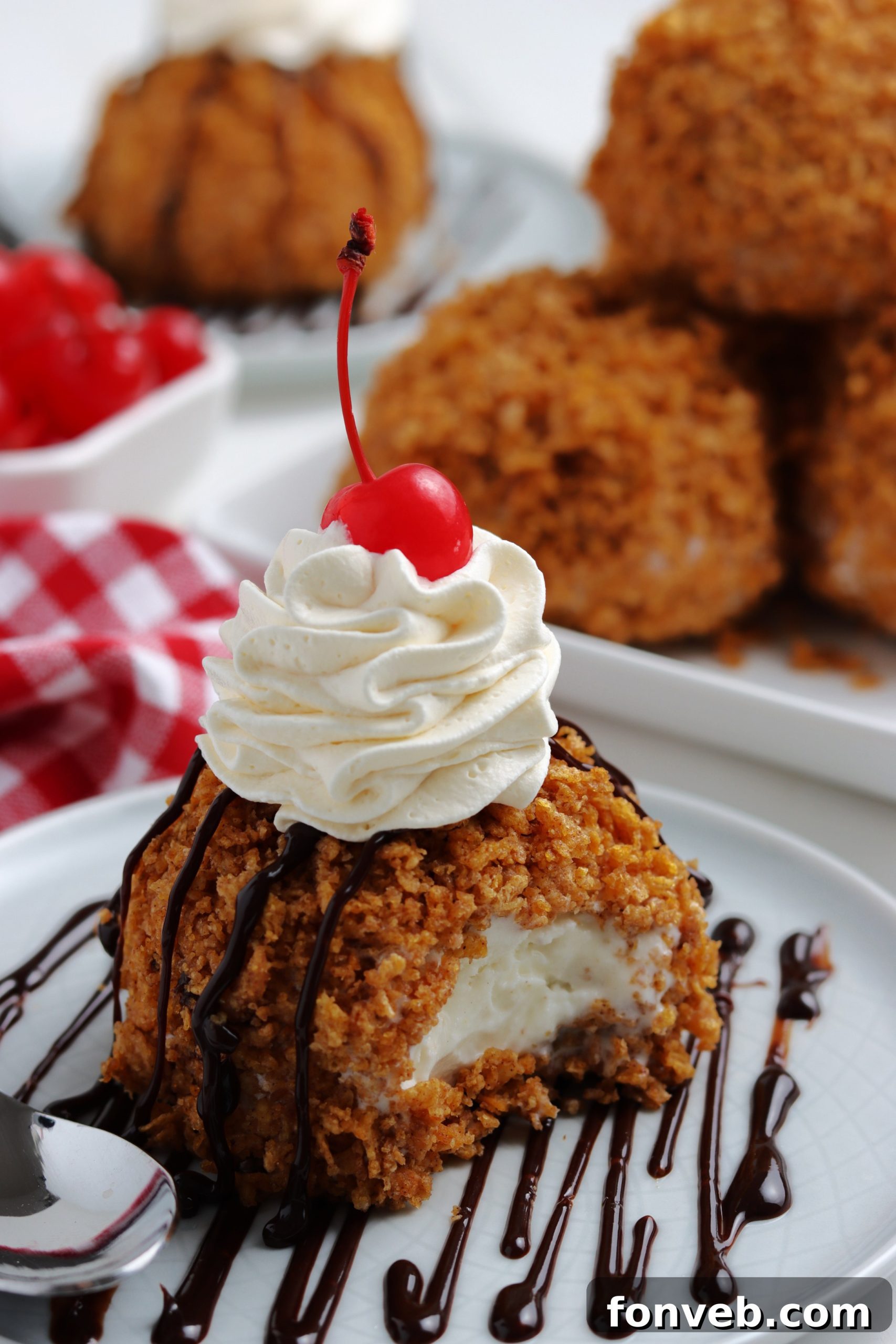 Golden-Fried Ice Cream Delight 2 Golden brown classic fried ice cream scoops topped with whipped cream and cherries