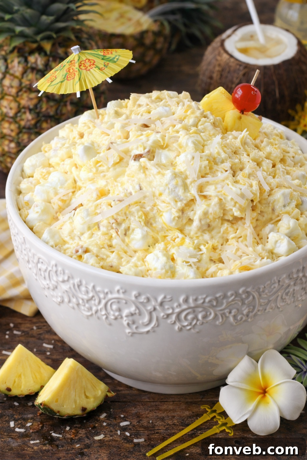 Close-up shot of a creamy Piña Colada Fluff in a glass bowl, showcasing its fluffy texture and tropical essence.