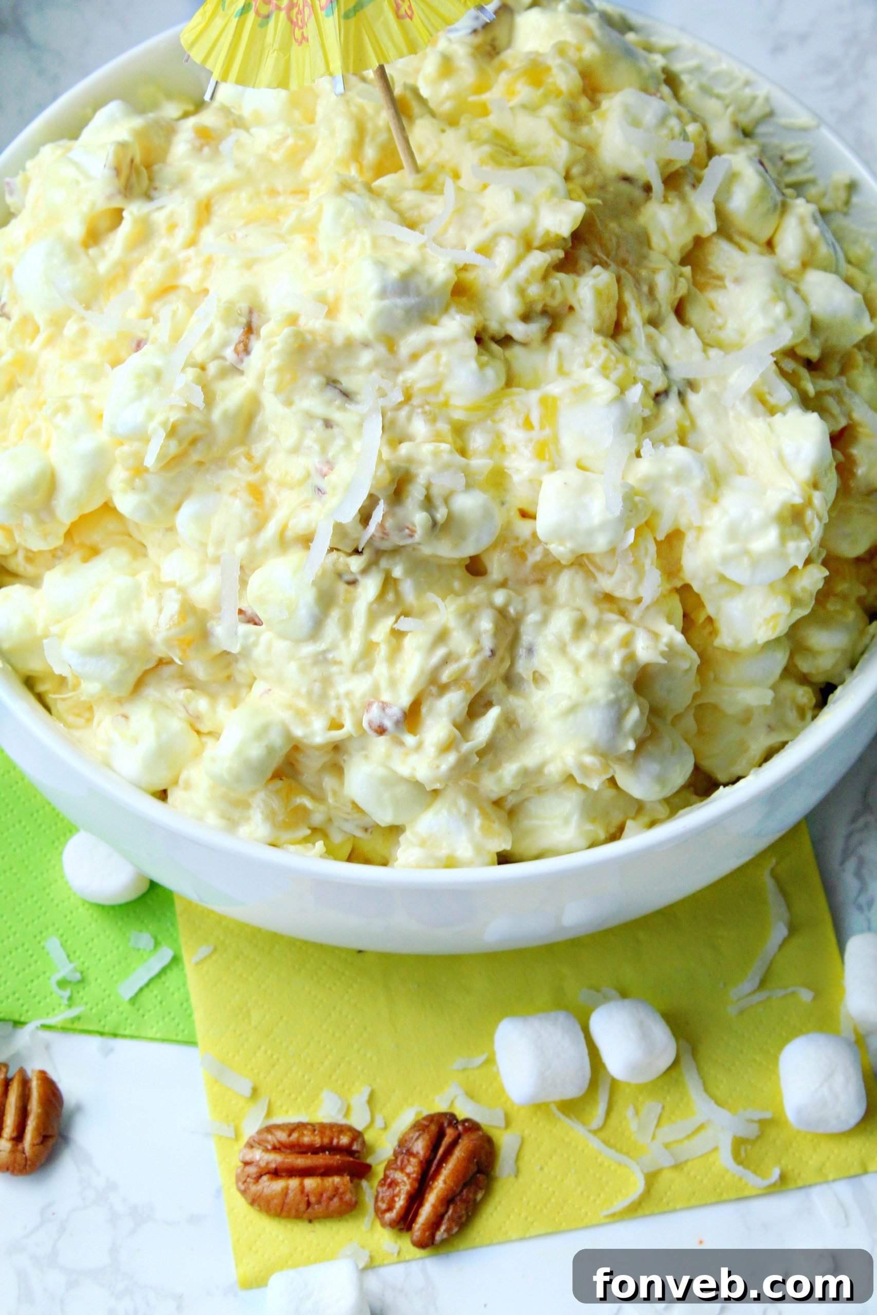 Close-up of Piña Colada Fluff in a white bowl, highlighting its creamy texture.