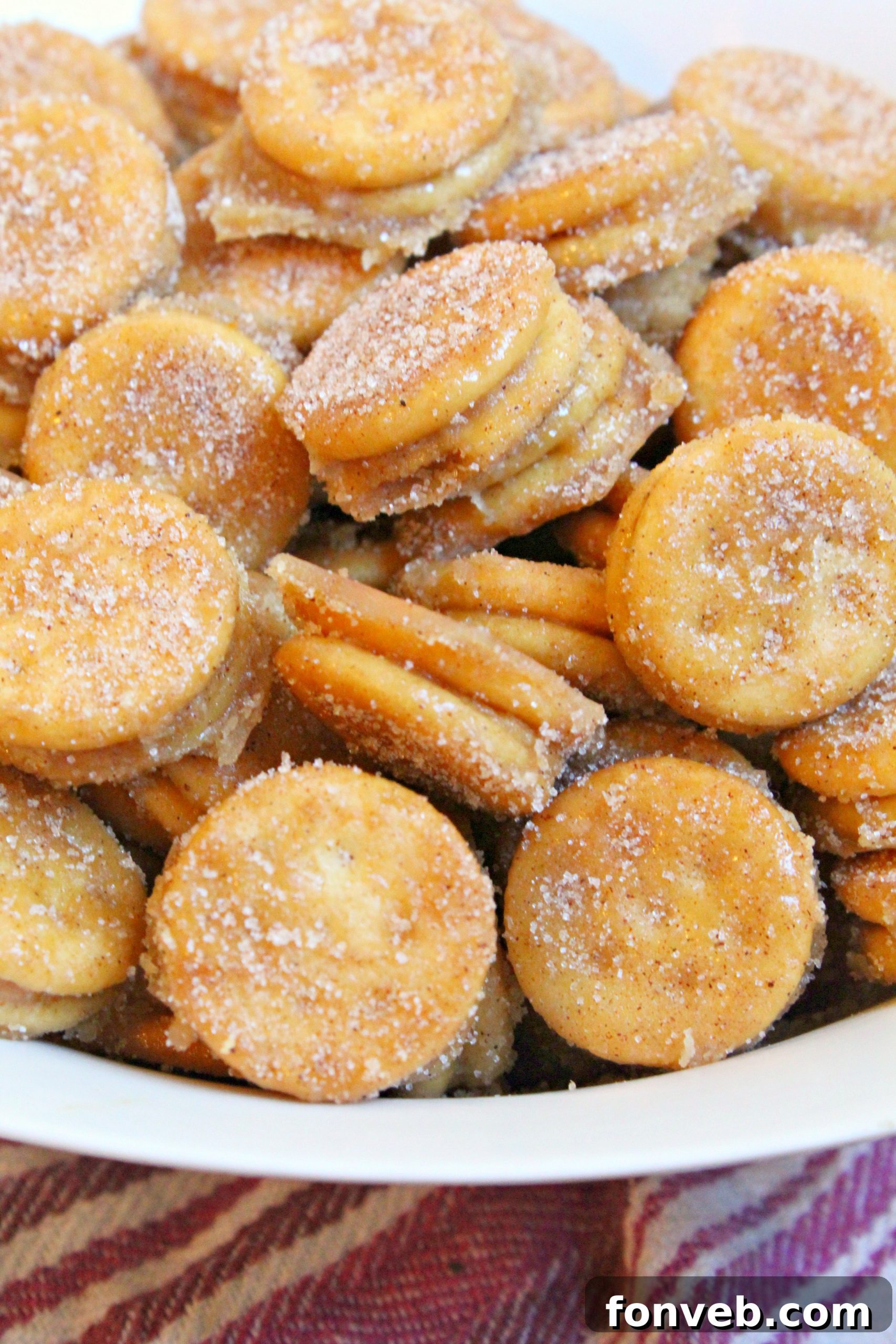 Freshly baked Ritz Churro Bites cooling on a baking sheet, glistening with cinnamon sugar.