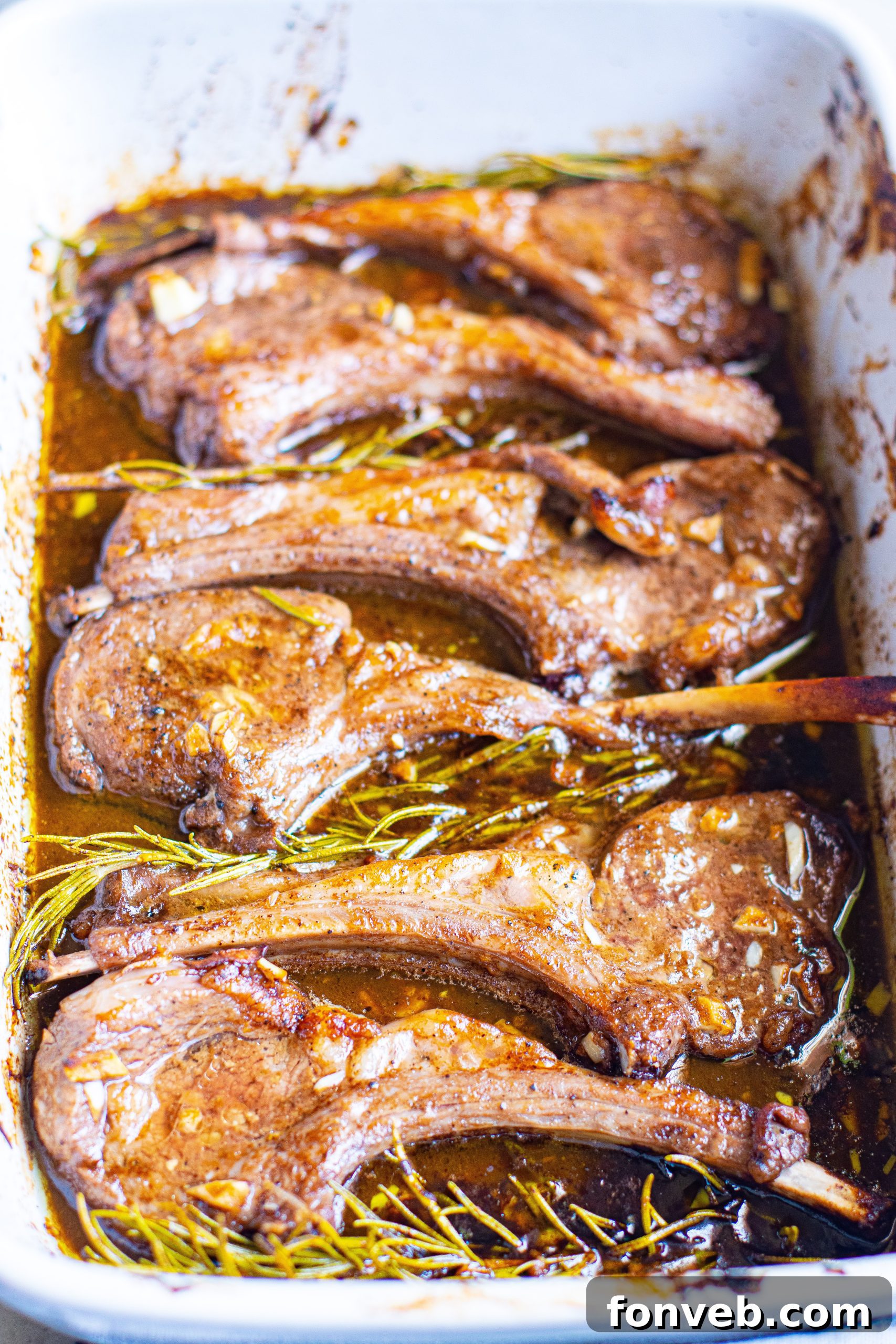 A plated meal of balsamic garlic lamb chops served with green beans and a side of creamy mashed potatoes