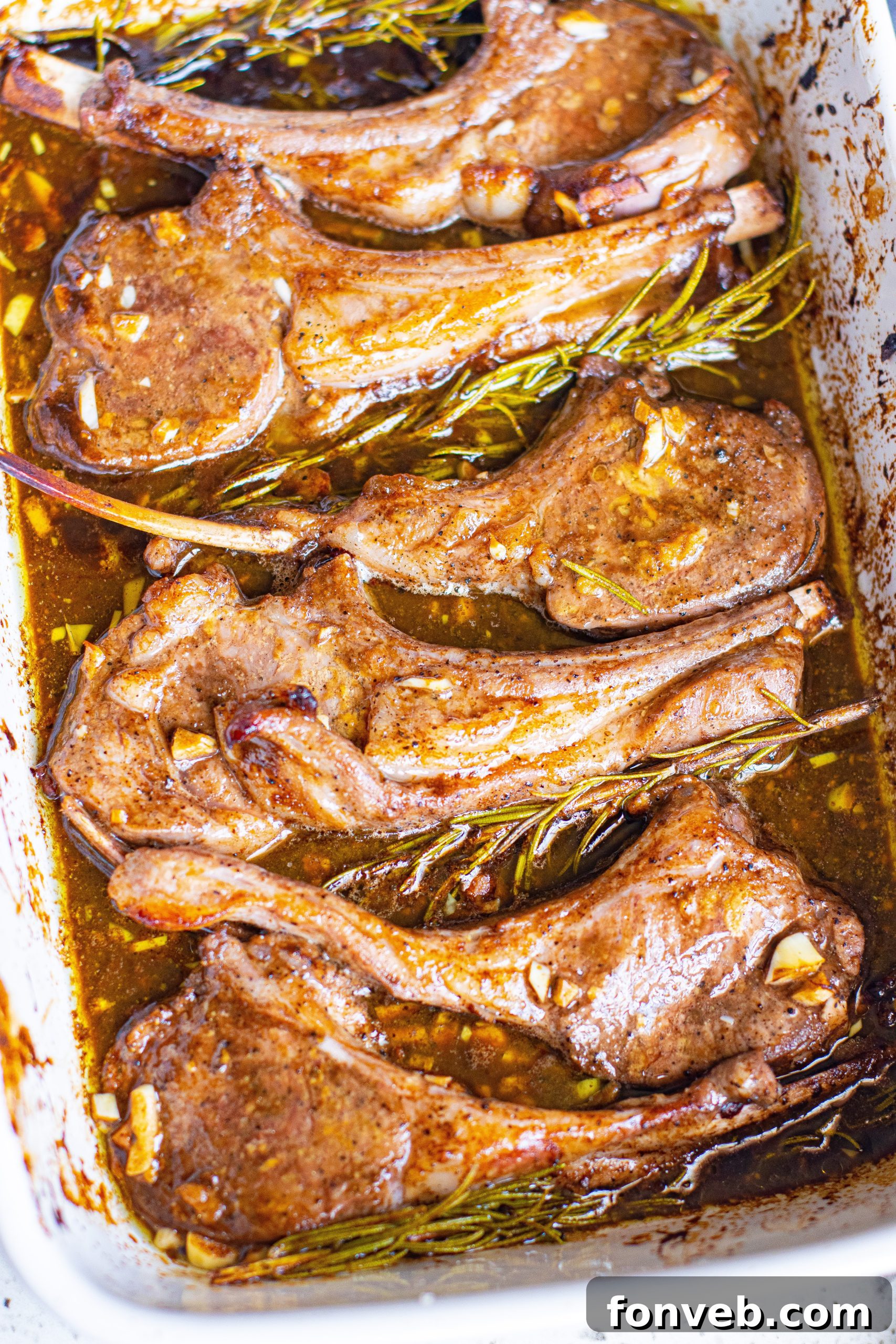 Fresh lamb chops being prepared on a cutting board, ready for seasoning and marination