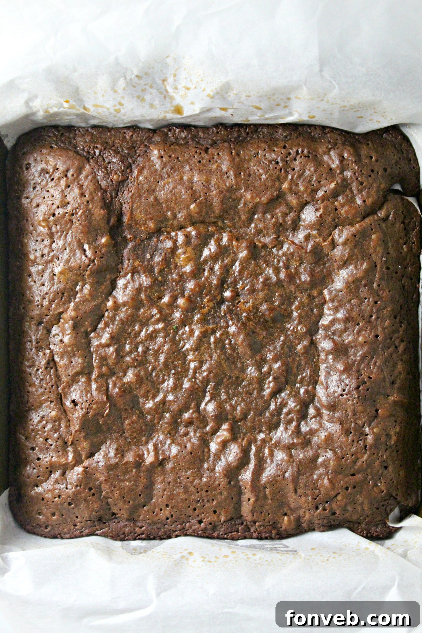 Another enticing shot of Dr. Pepper brownies, stacked slightly, showing off their glistening, rich surface and tantalizing texture.