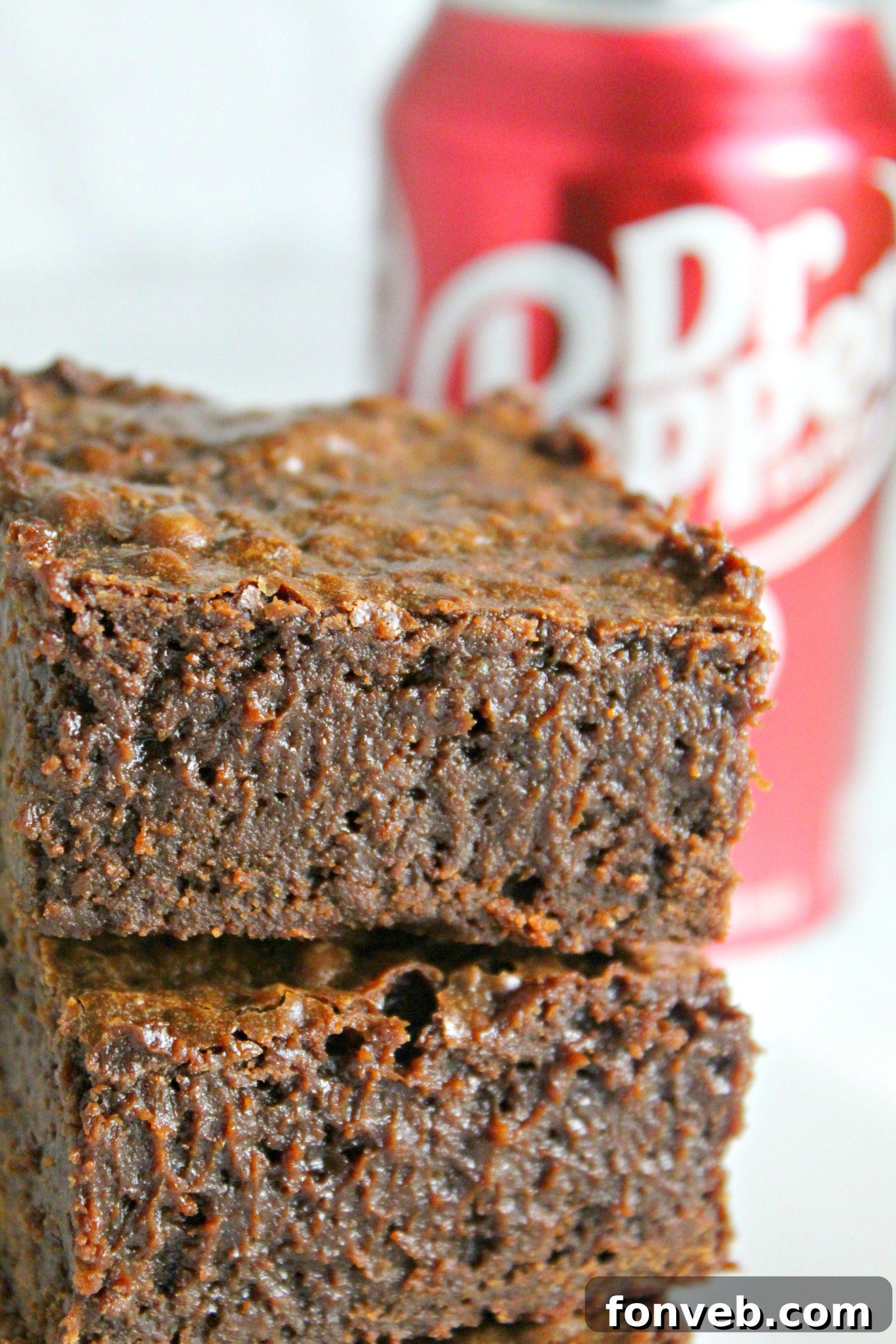 A beautifully cut Dr. Pepper brownie, perfectly shaped and ready to be enjoyed, showcasing its rich brown color and delightful texture.