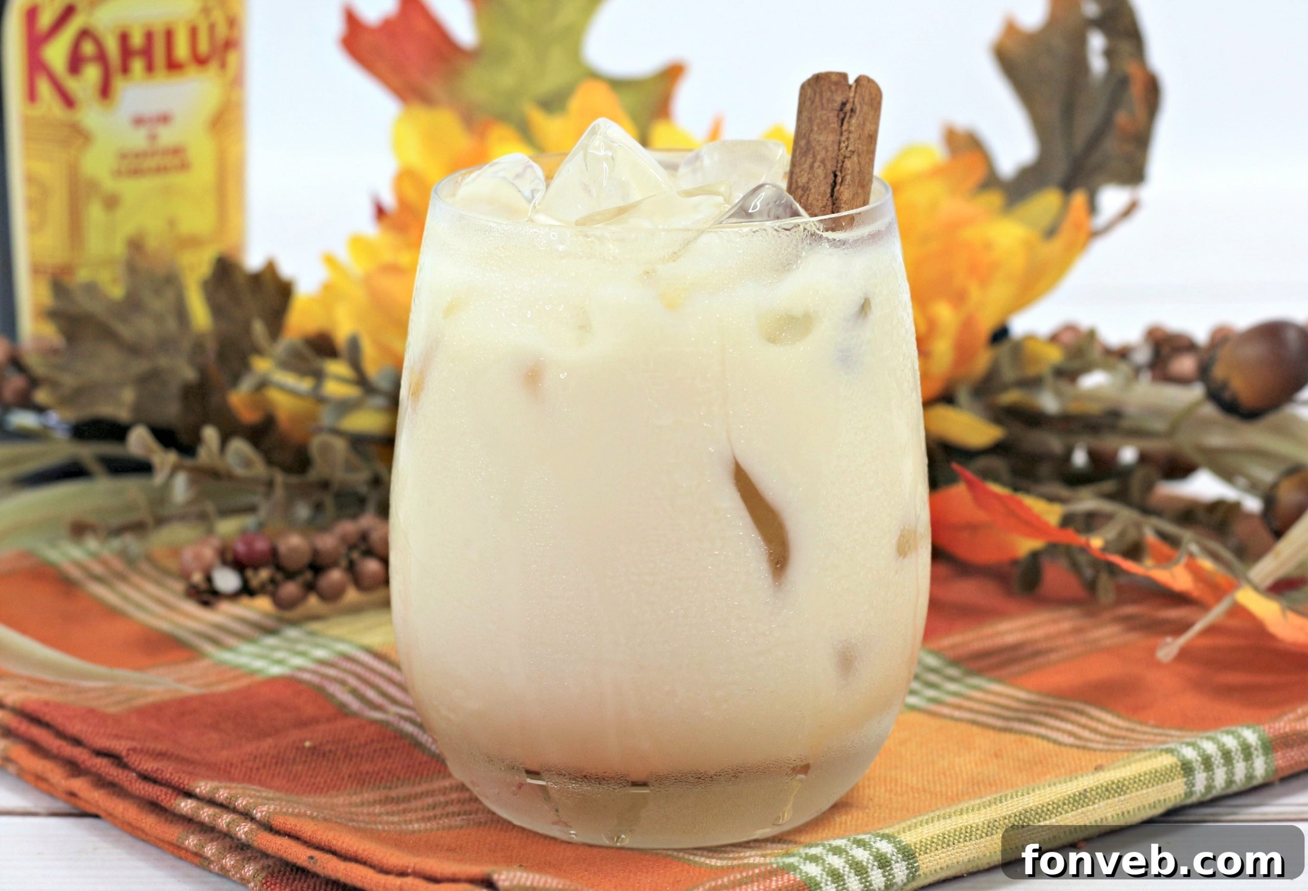 Close-up of a Pumpkin Spice White Russian cocktail showing its creamy texture and rich color, garnished with a dash of spice.
