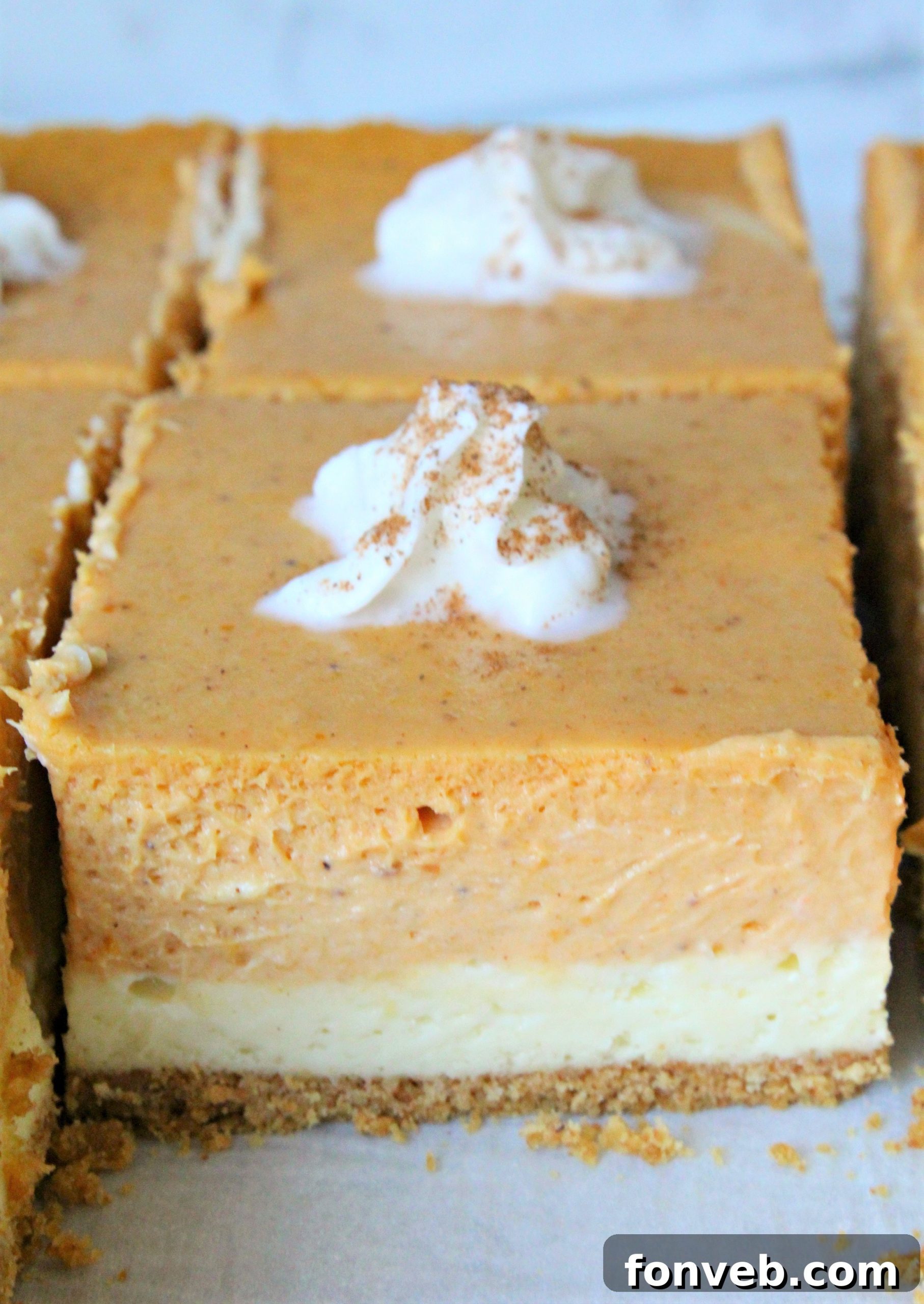 Delicious Pumpkin Cheesecake Bars with a flaky graham cracker crust, perfect for fall