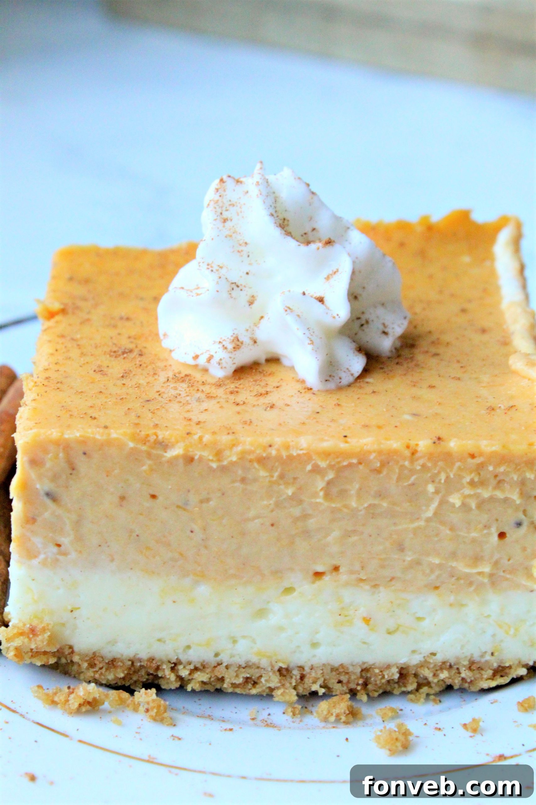 A pan of freshly baked Pumpkin Cheesecake Bars cooling on a wire rack