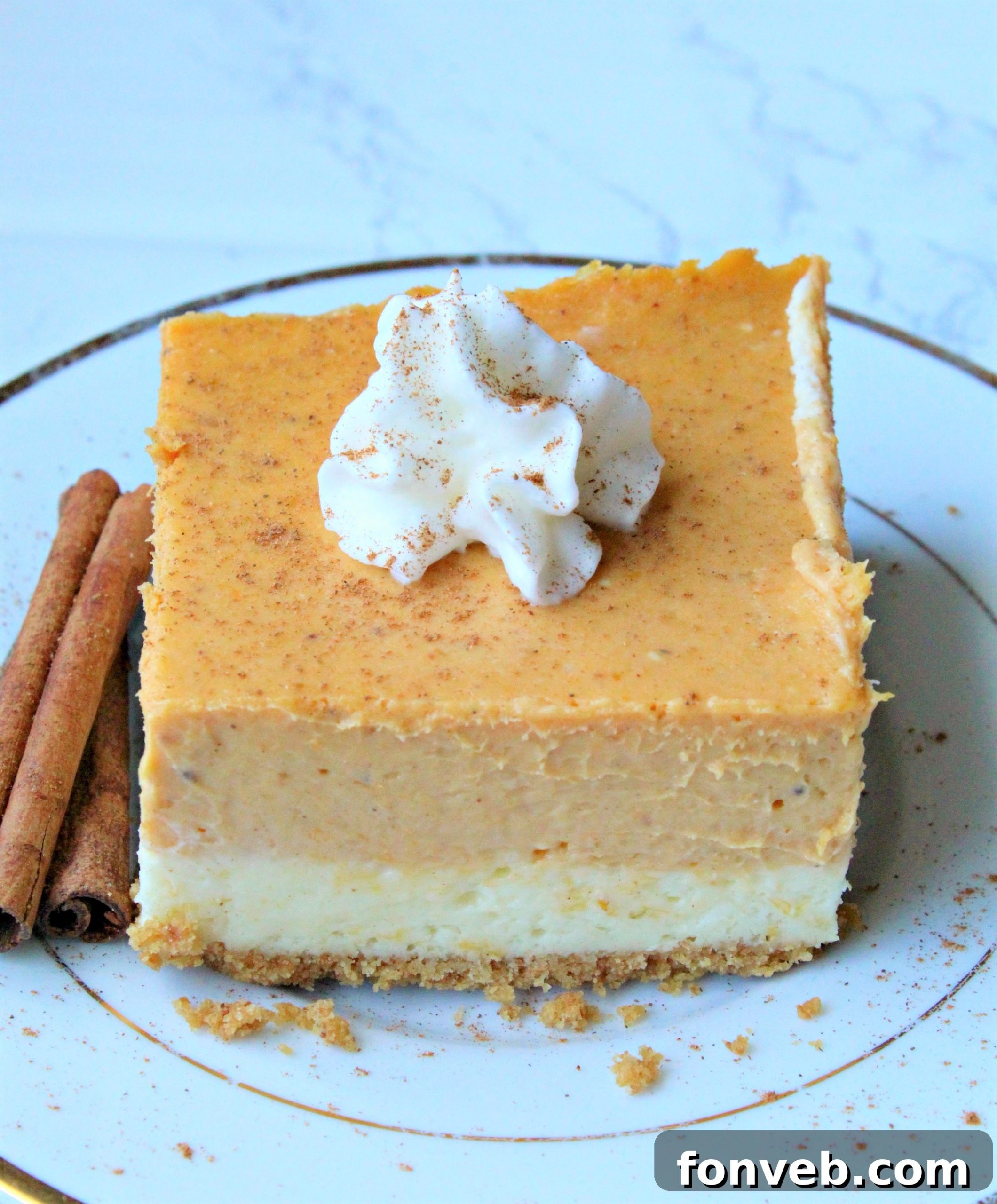 Pumpkin Cheesecake Bars elegantly drizzled with sweet caramel sauce