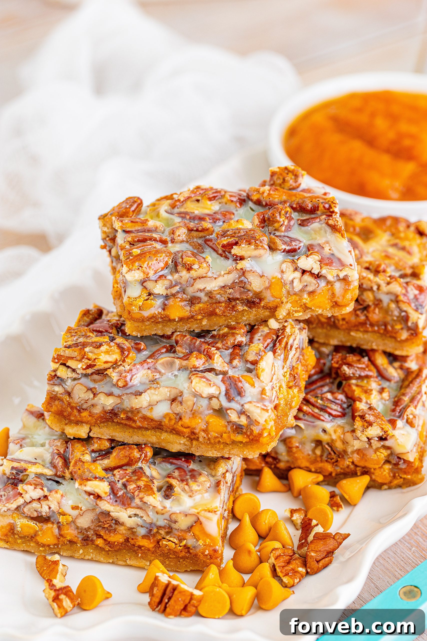Close-up of golden brown Pumpkin Pecan Magic Bars fresh out of the oven, showing the crisp edges and gooey toppings. A perfect blend of fall flavors.