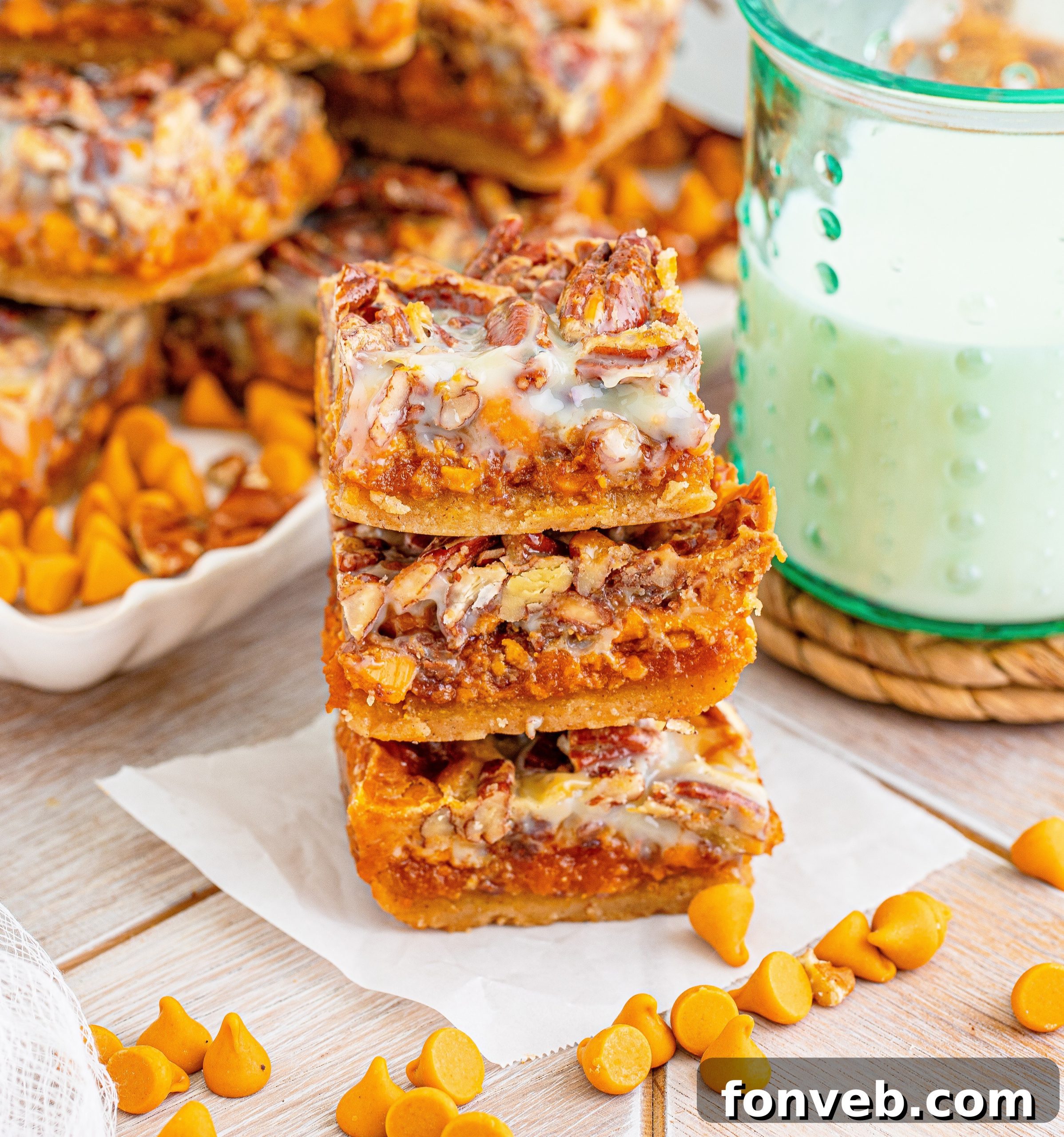 Stack of Pumpkin Pecan Magic Bars on a white plate, showcasing their inviting layers of pumpkin, pecans, and toffee, ready to be enjoyed.