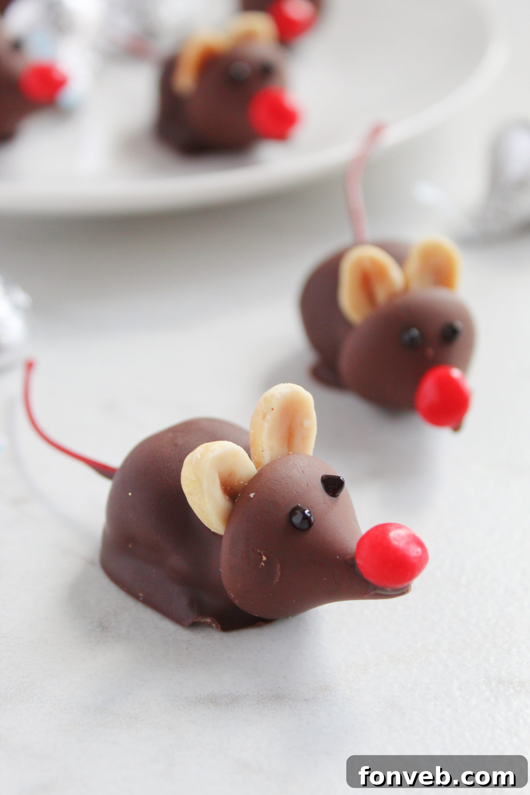 Hershey's Whimsical Winter Mice 2 Close-up of Hershey's Christmas Mice Candy with a red hot nose and cherry stem tail
