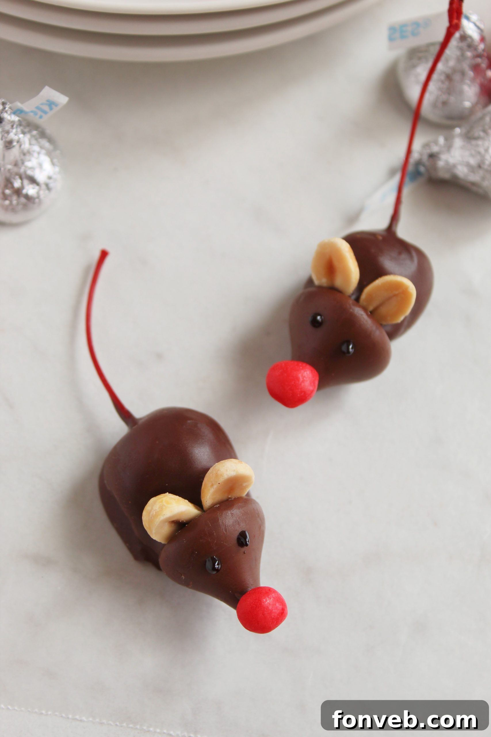 Hershey's Whimsical Winter Mice 5 Hands arranging Hershey's Christmas Mice Candy on a plate