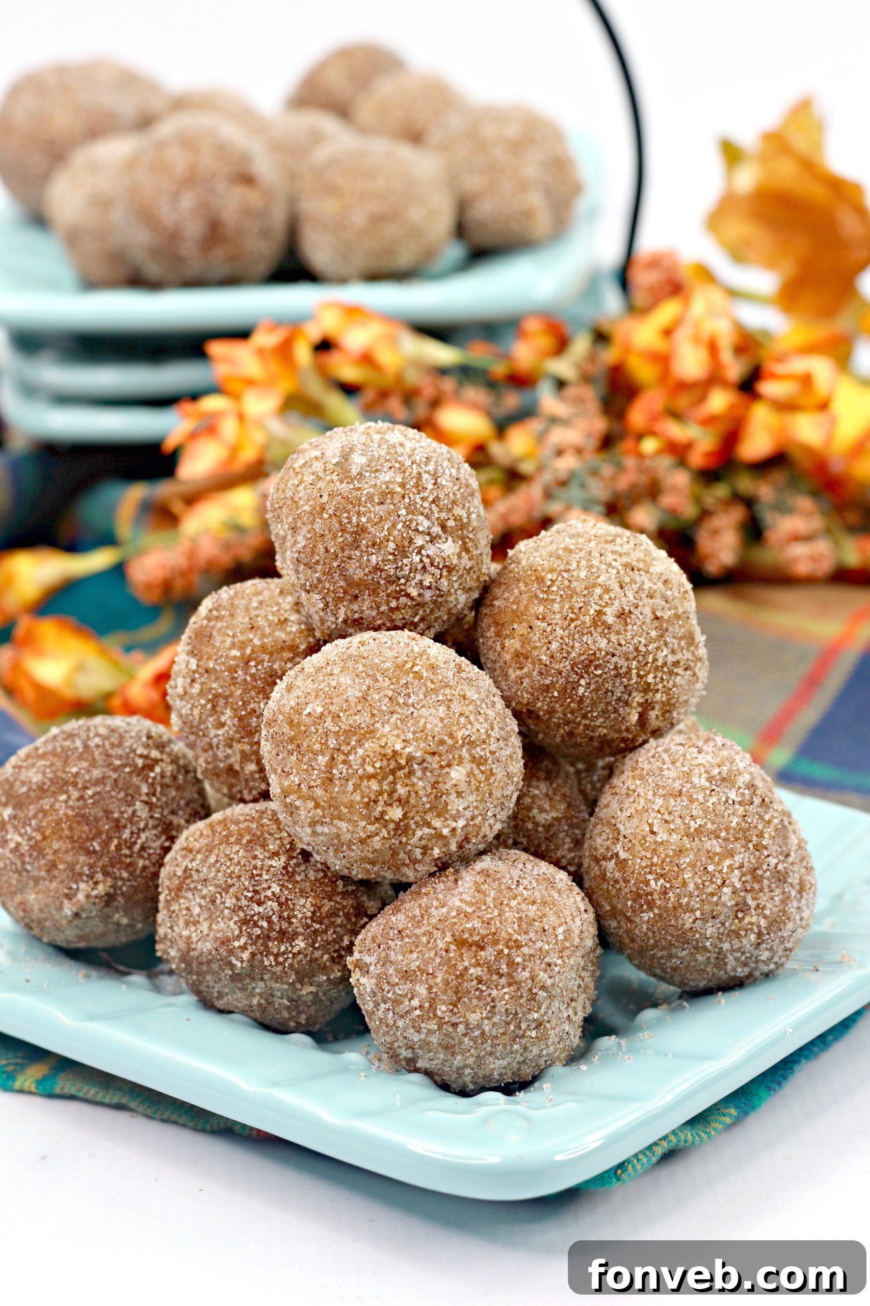 Delicious baked pumpkin snickerdoodle donut holes stacked on a wooden board