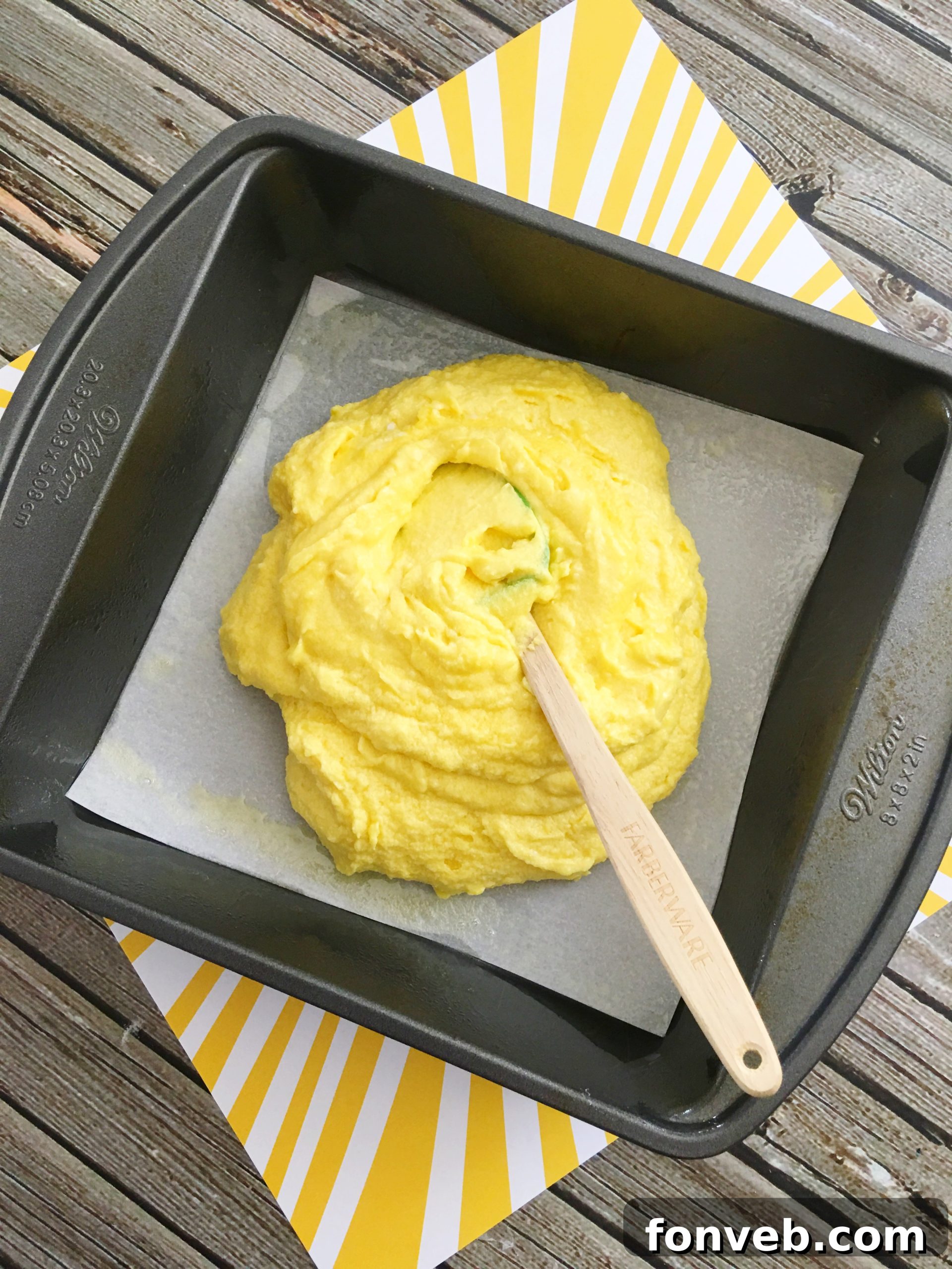 Close-up of lemon brownie with cream cheese swirl and yellow sprinkles