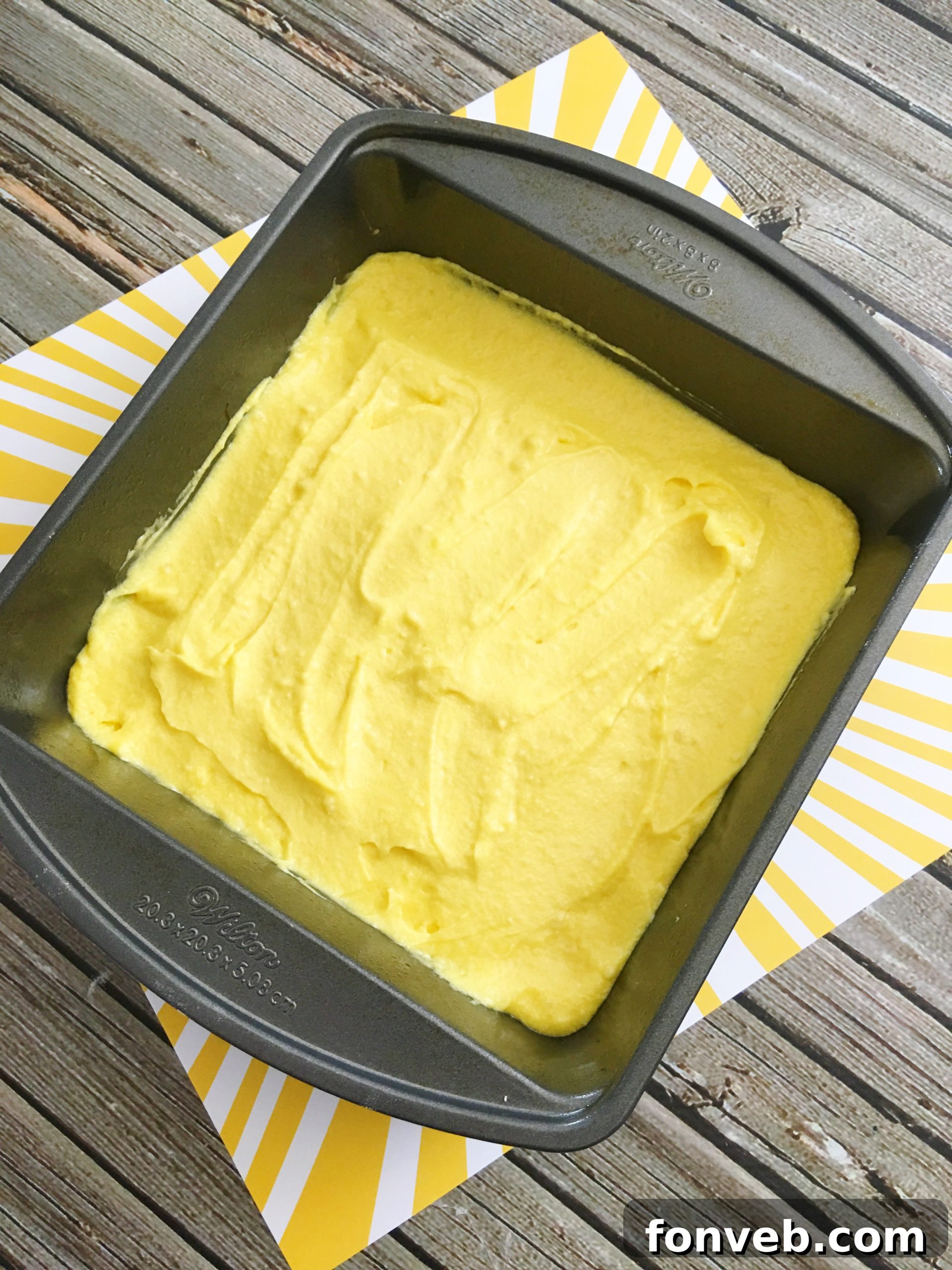 Stack of lemon cream cheese brownies on a plate