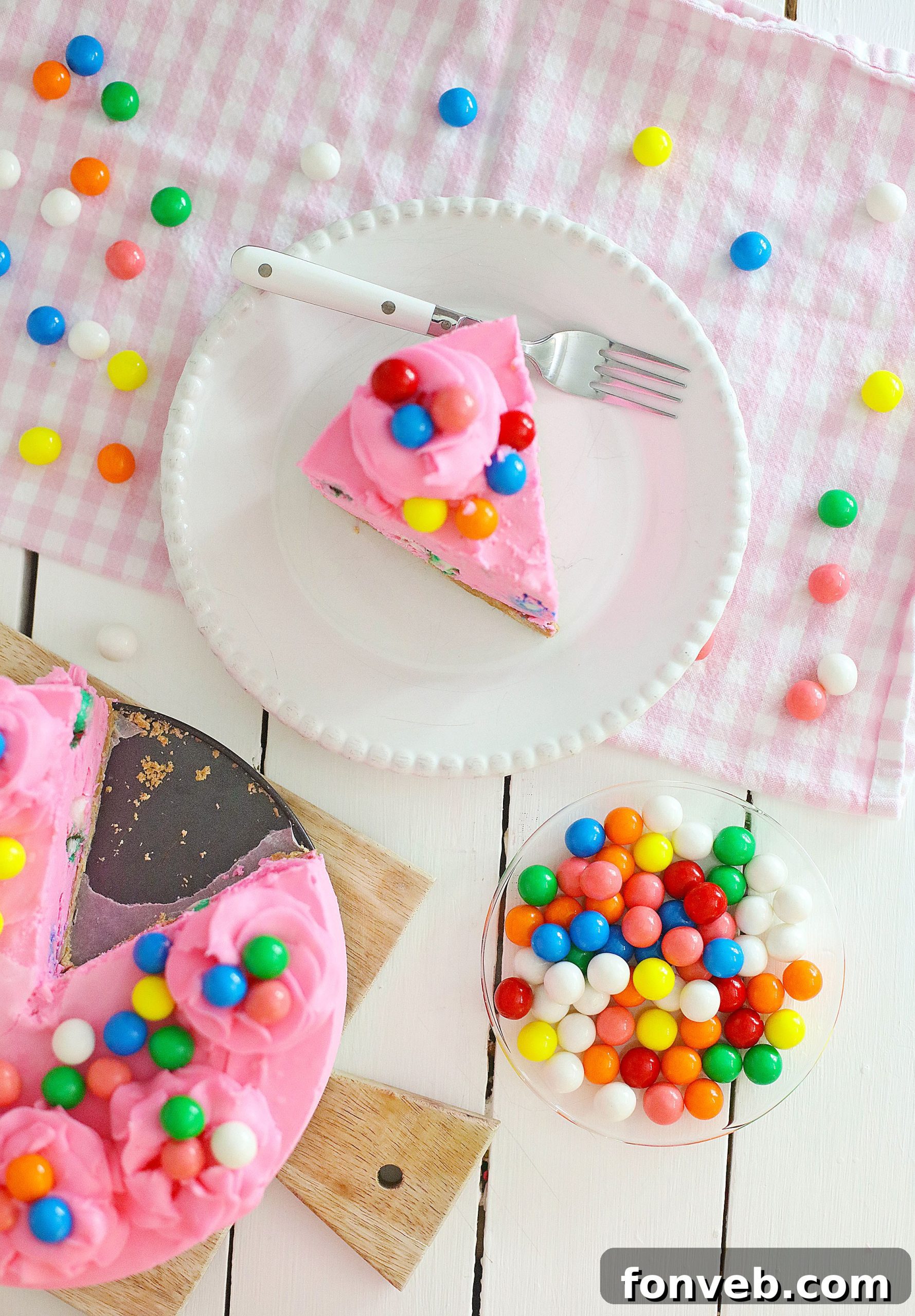 A final close-up of the complete bubblegum cheesecake, showcasing its full decorative glory and inviting visual appeal, with a perfect piped frosting border.
