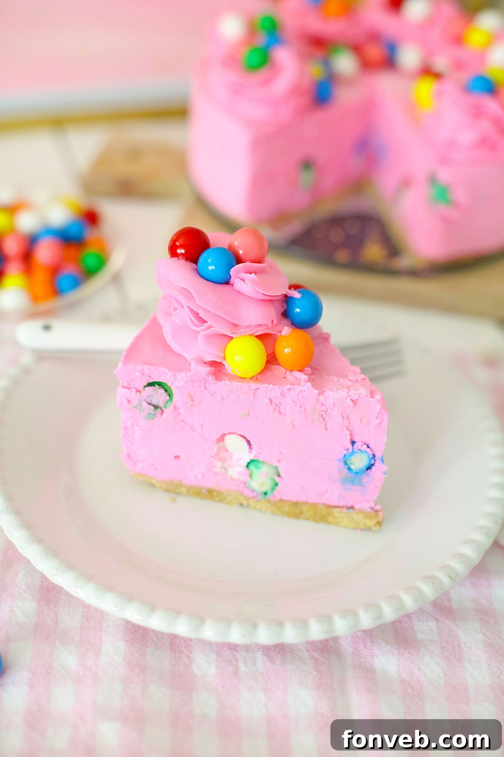 Another enticing close-up of a bubblegum cheesecake slice, emphasizing the perfect layering and the delightful texture of the gumballs.