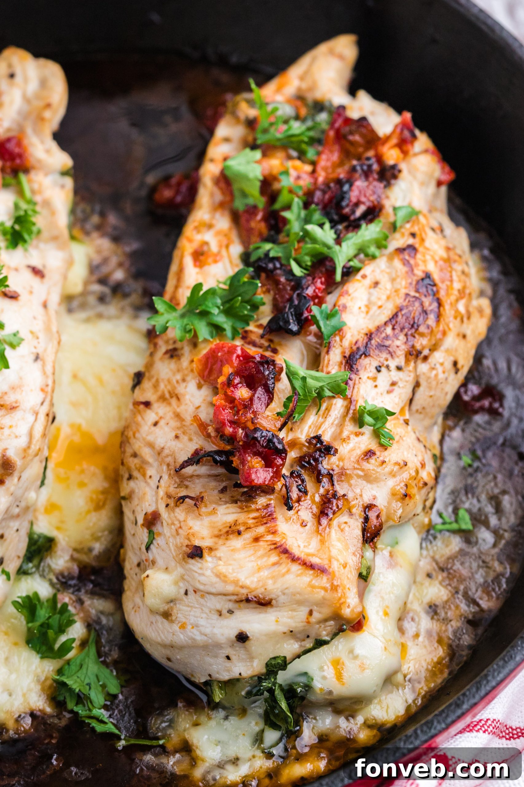 A chef's knife carefully cutting a pocket into a chicken breast for stuffing