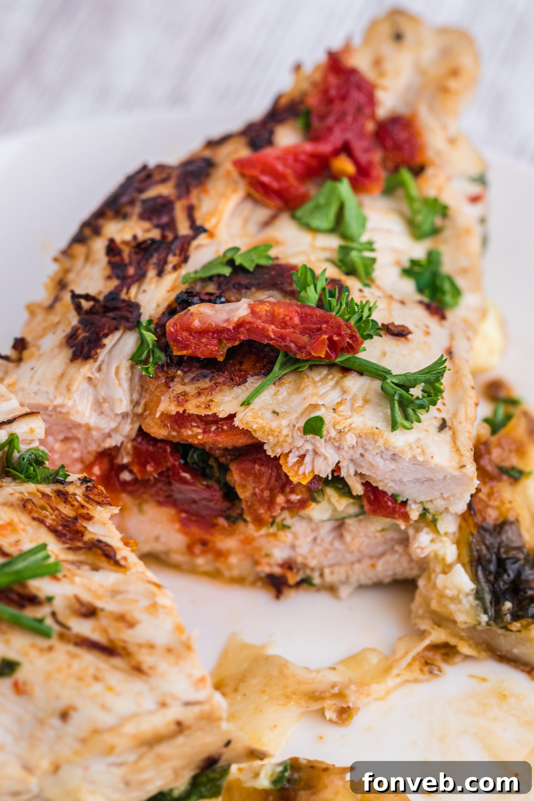 Fresh spinach and sun-dried tomatoes being chopped for the stuffing