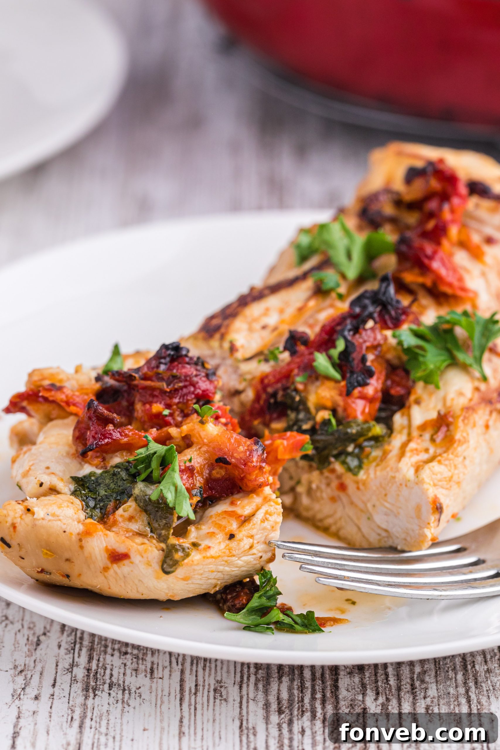 A close-up view of the golden-brown, seared stuffed chicken breast