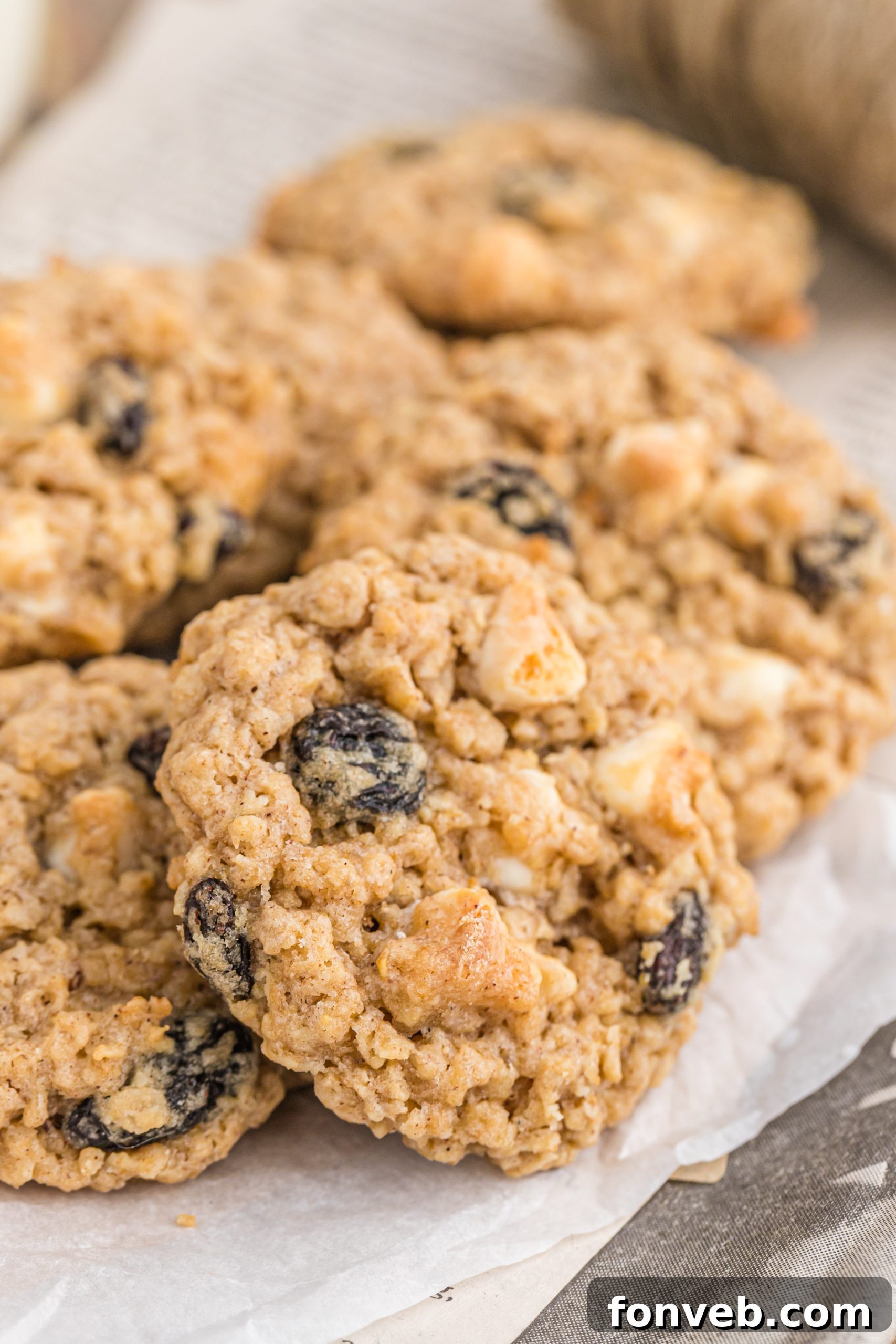 Soft oatmeal raisin cookie broken in half to show texture