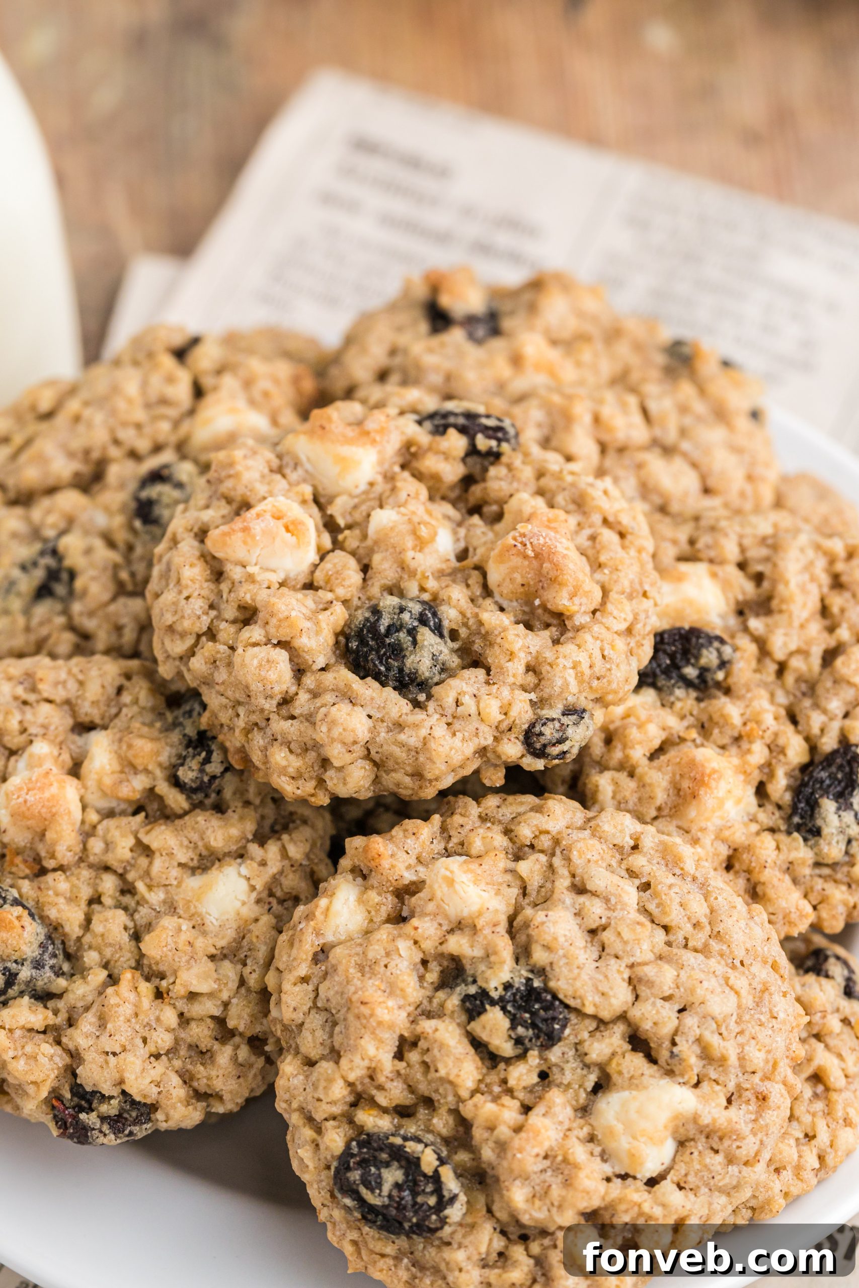 Closeup of a freshly baked oatmeal raisin cookie on a wooden surface