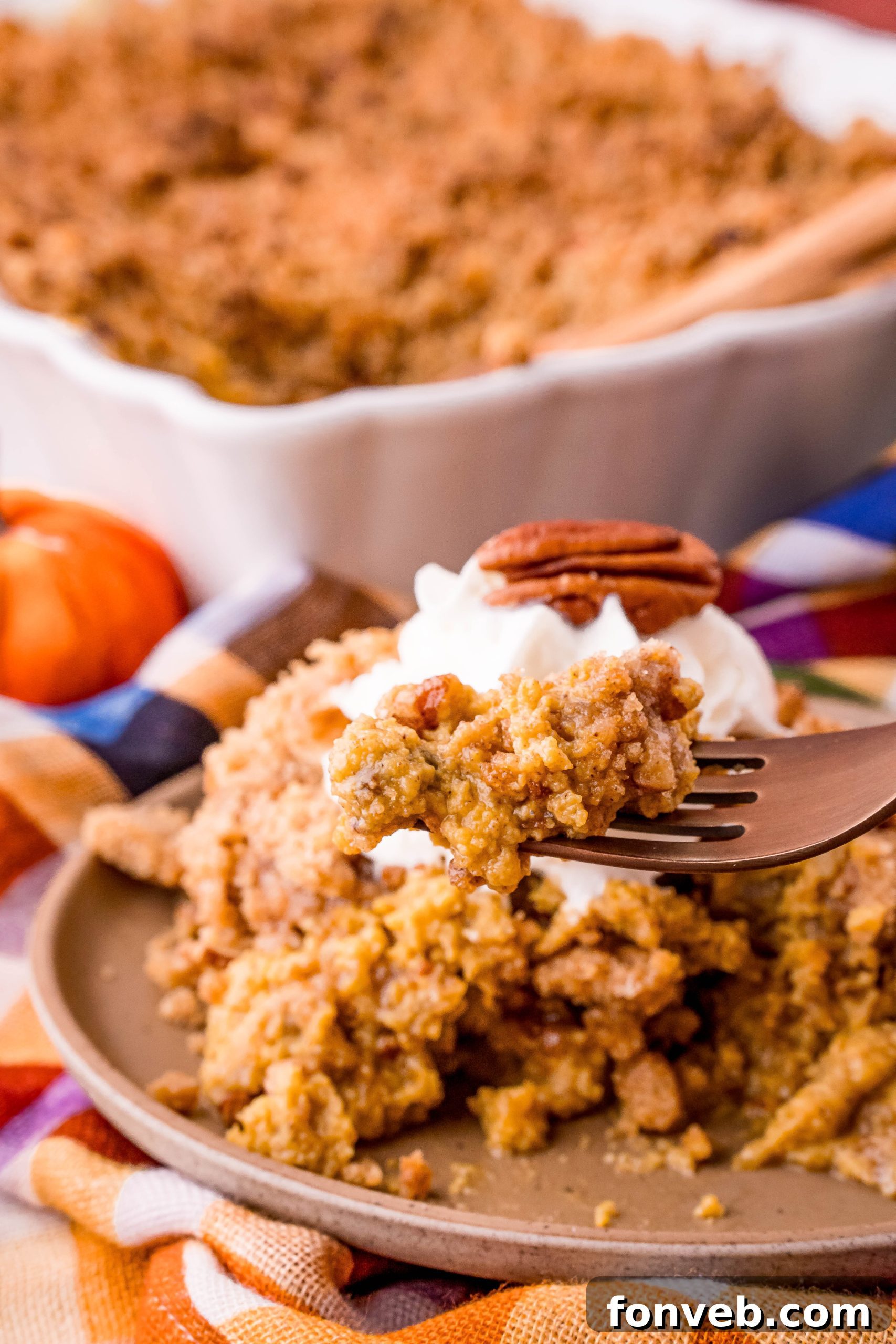 A serving of pumpkin crisp with whipped cream