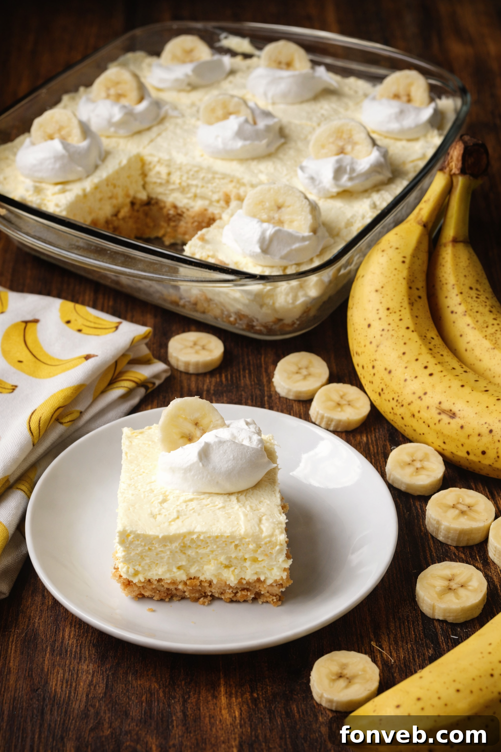A cutting board with a knife and several Banana Cream Cheesecake Bars, showcasing their clean slices and smooth texture.