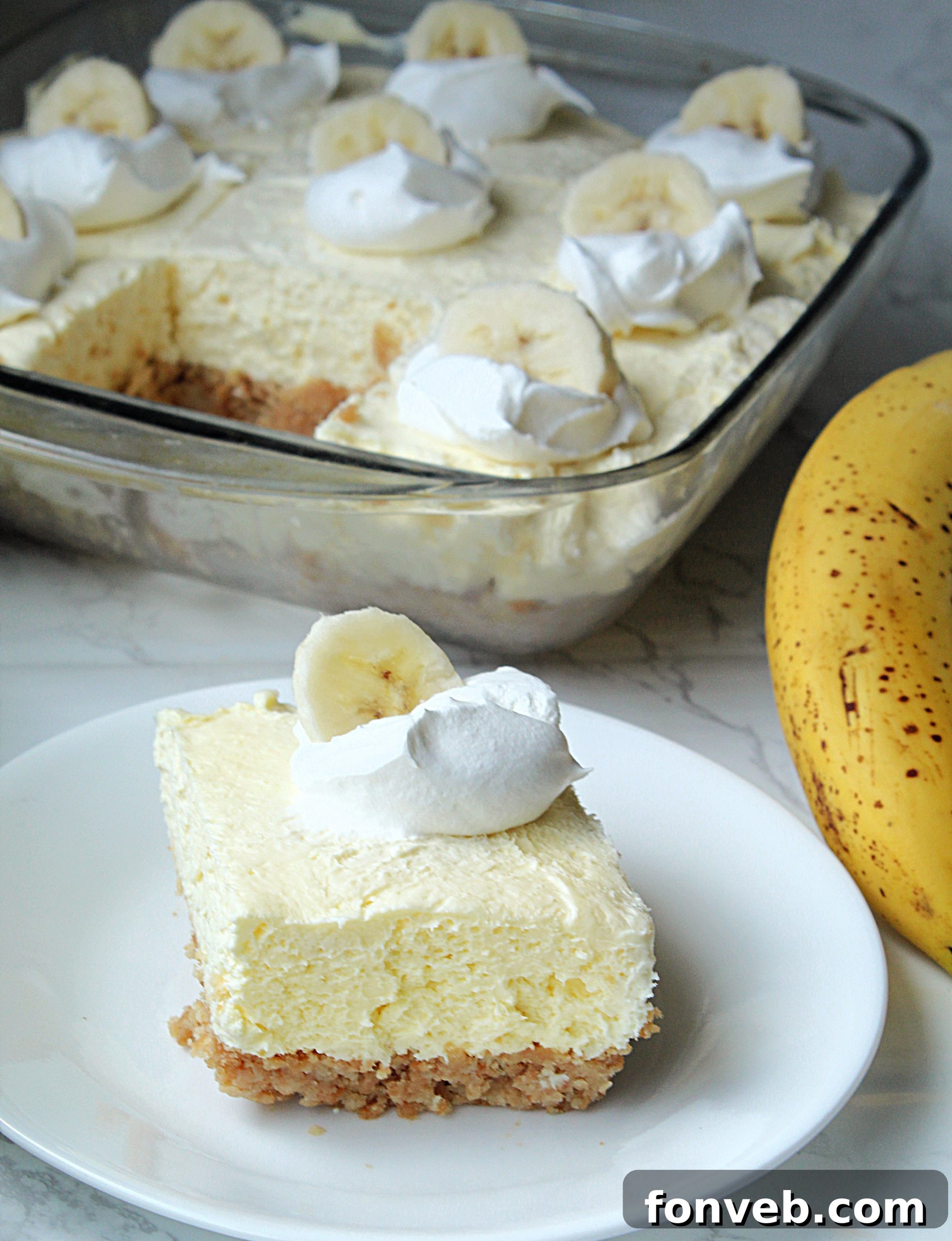 A stack of frozen Banana Cream Cheesecake Bars, individually wrapped in foil, ready for long-term storage.
