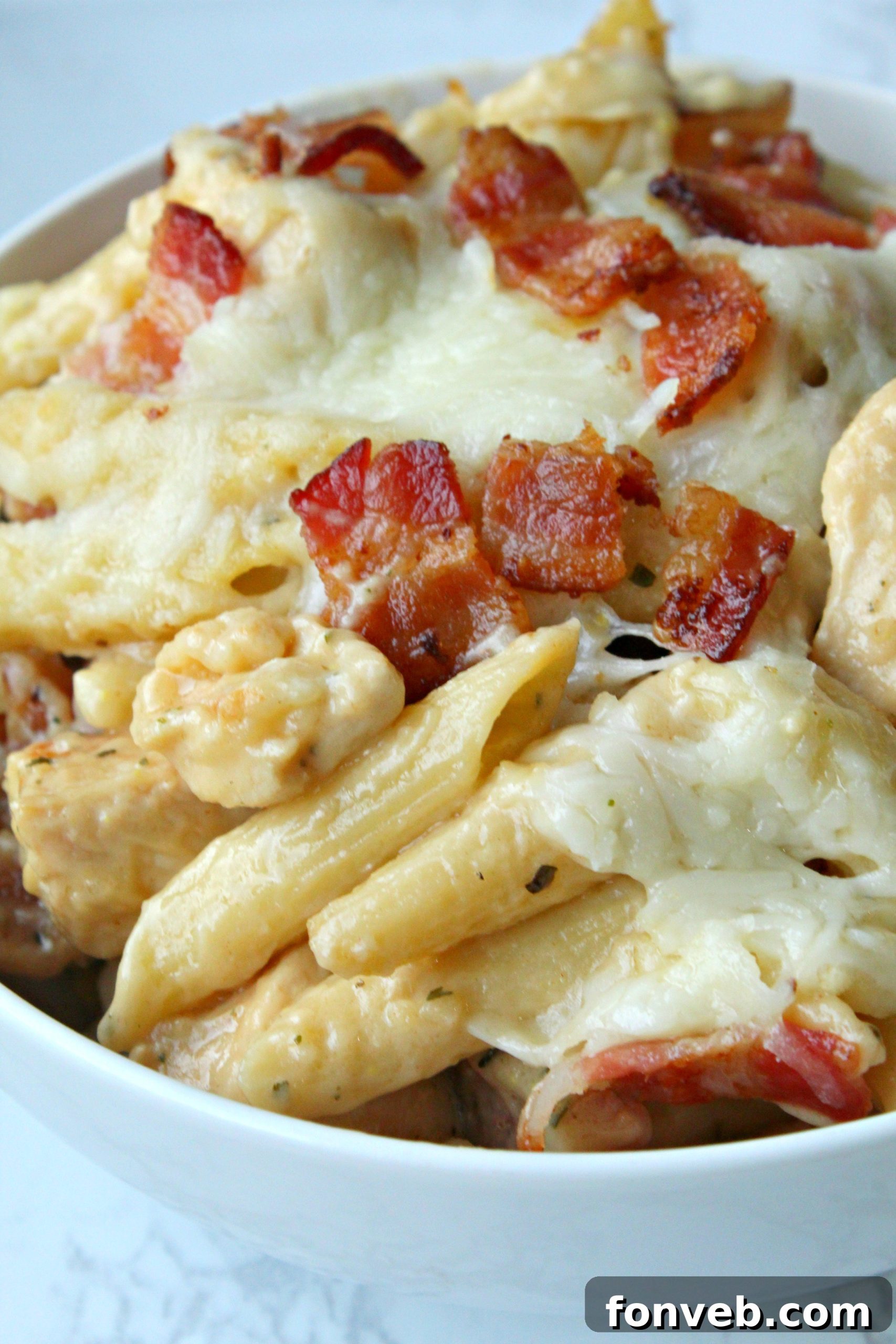 Another close-up of the Chicken Bacon Ranch Penne, emphasizing the golden-brown crust and melted cheese on top.
