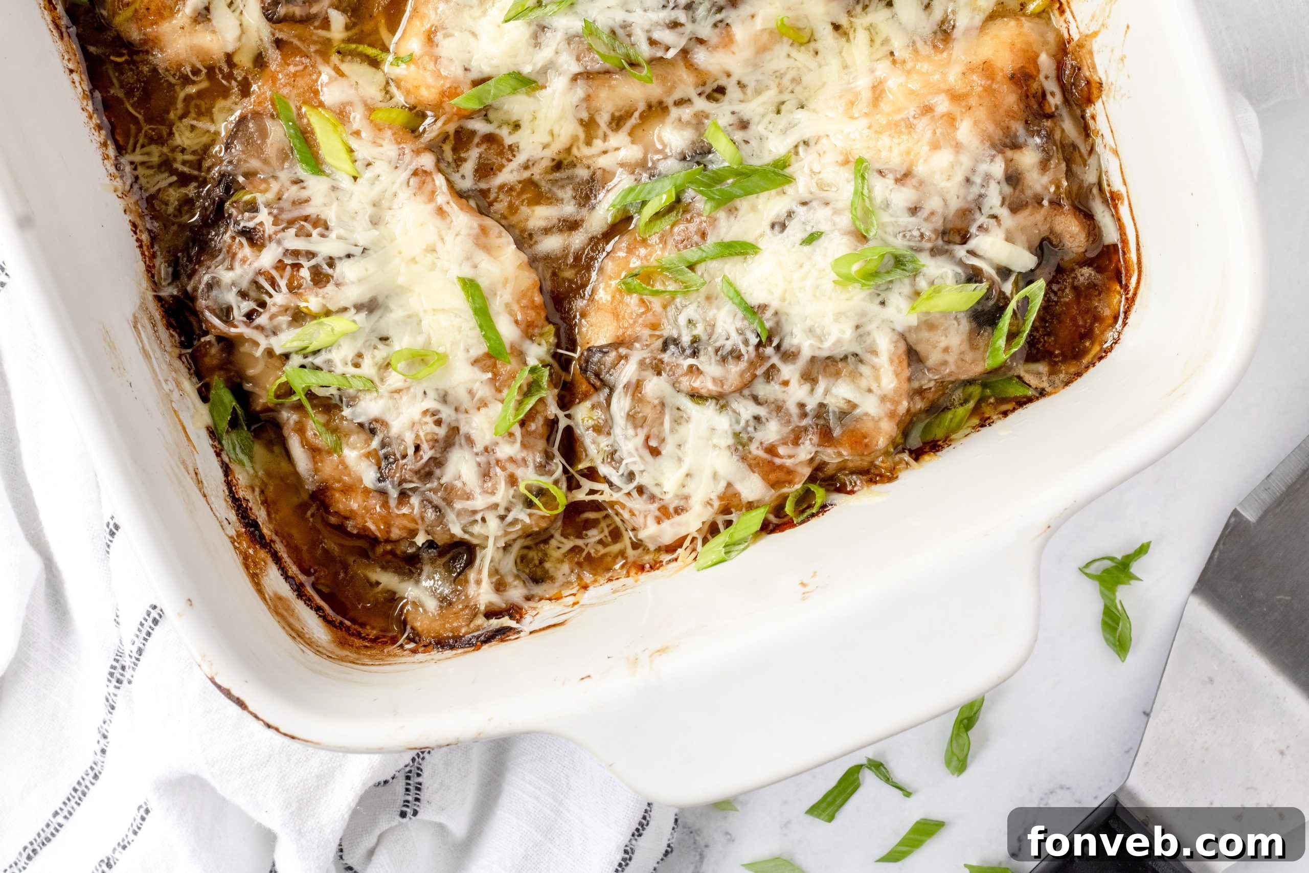 Chicken Lombardy dish garnished with green onions and parsley