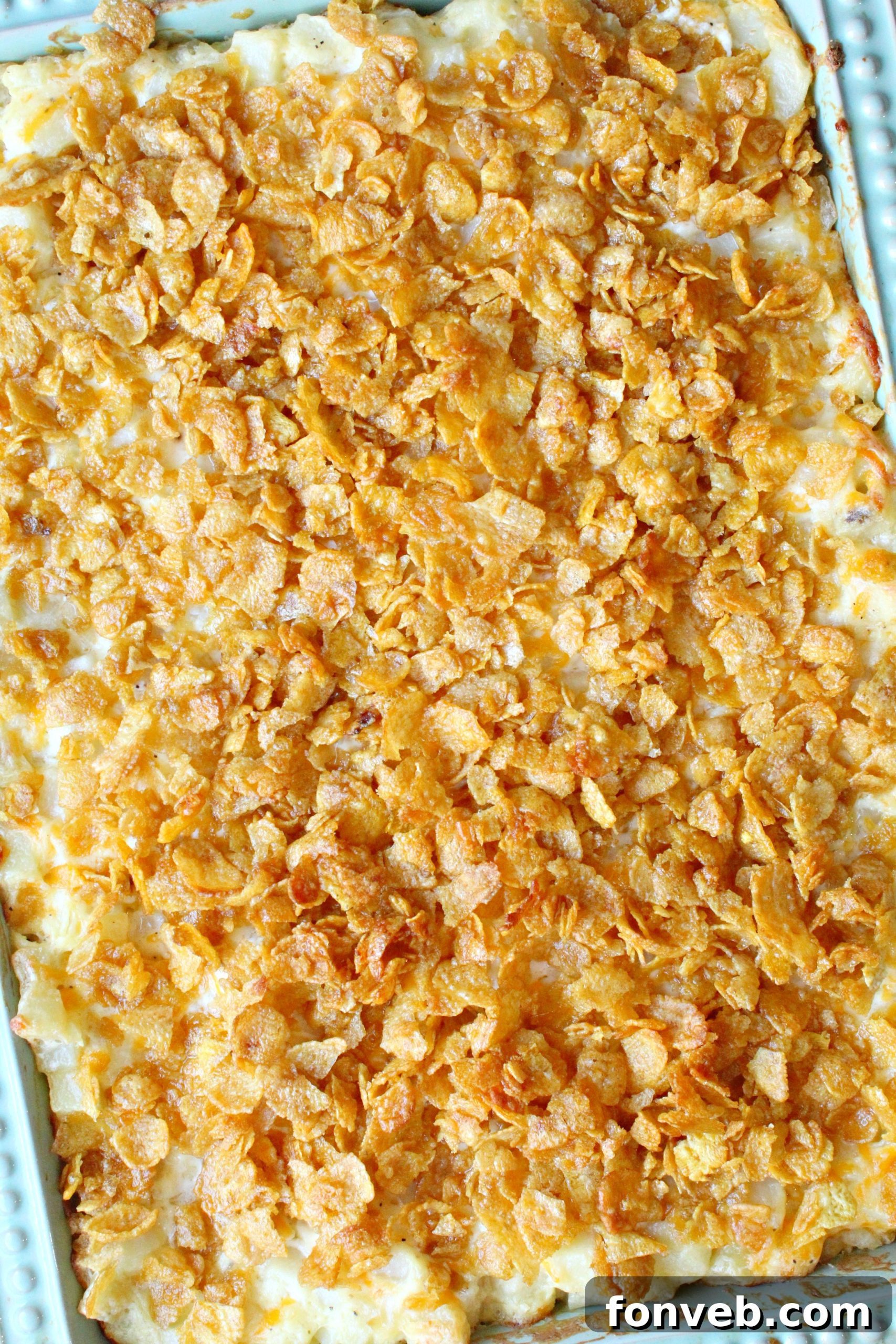 Overhead view of Funeral Potatoes in a baking pan, showing the golden texture