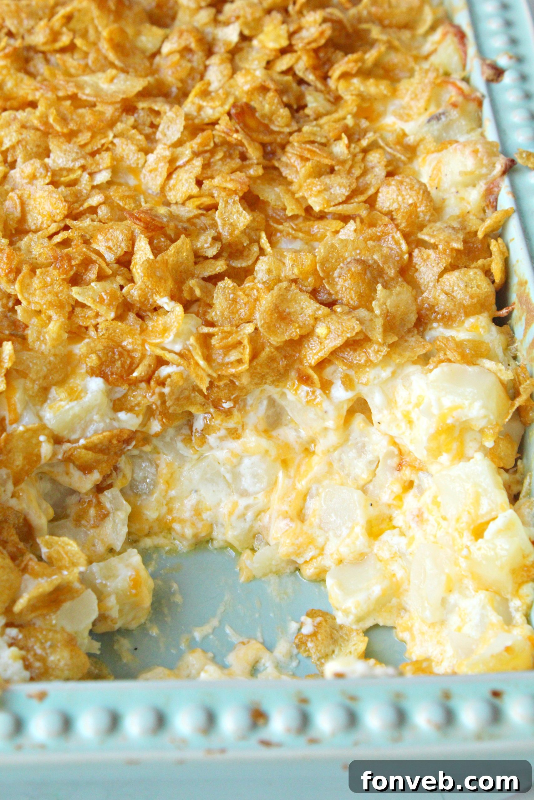 Funeral Potatoes baked to perfection in a vibrant green baking pan