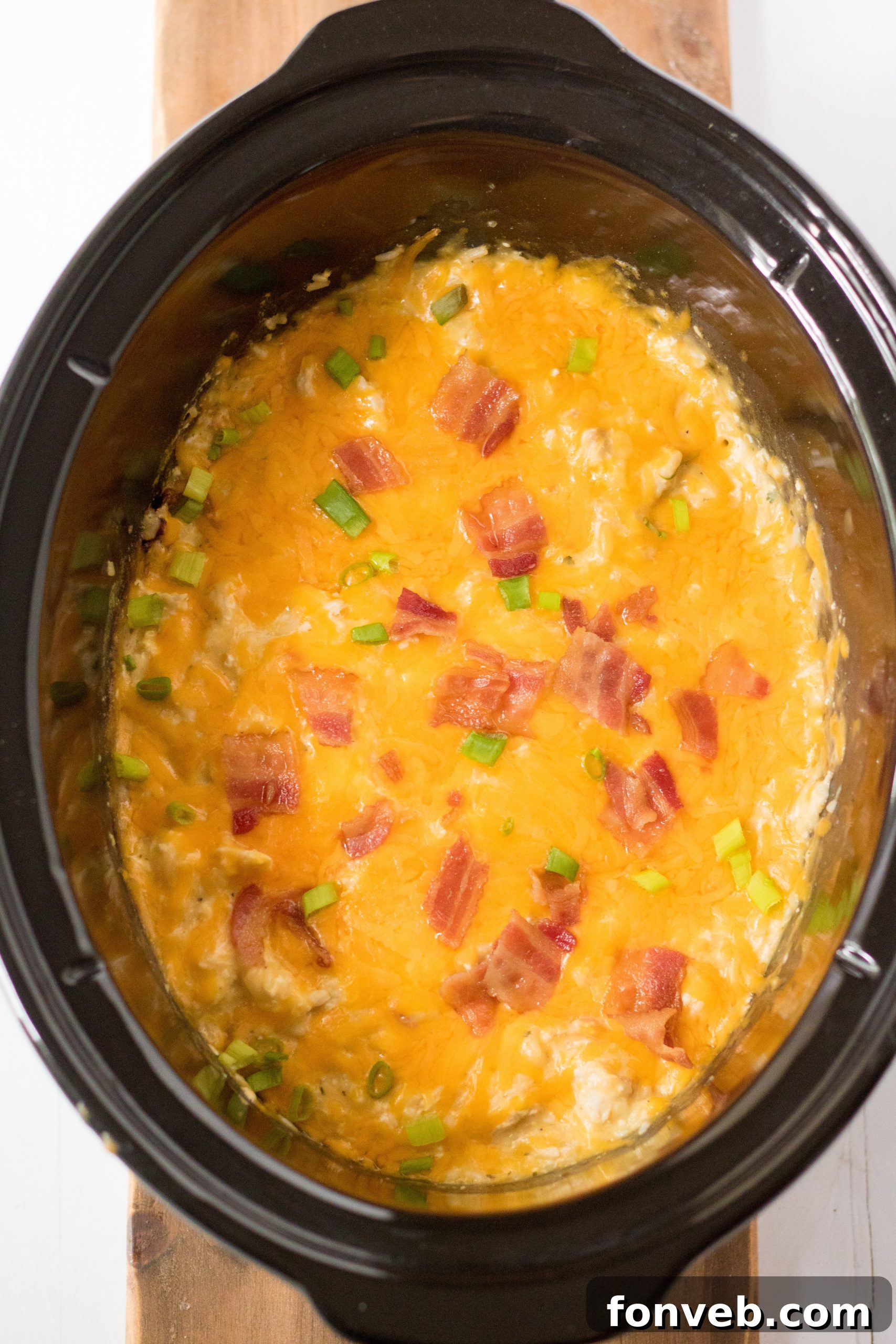 A generous serving of Slow Cooker Cheesy Crack Chicken and Rice, paired with a fresh green salad and dinner rolls.