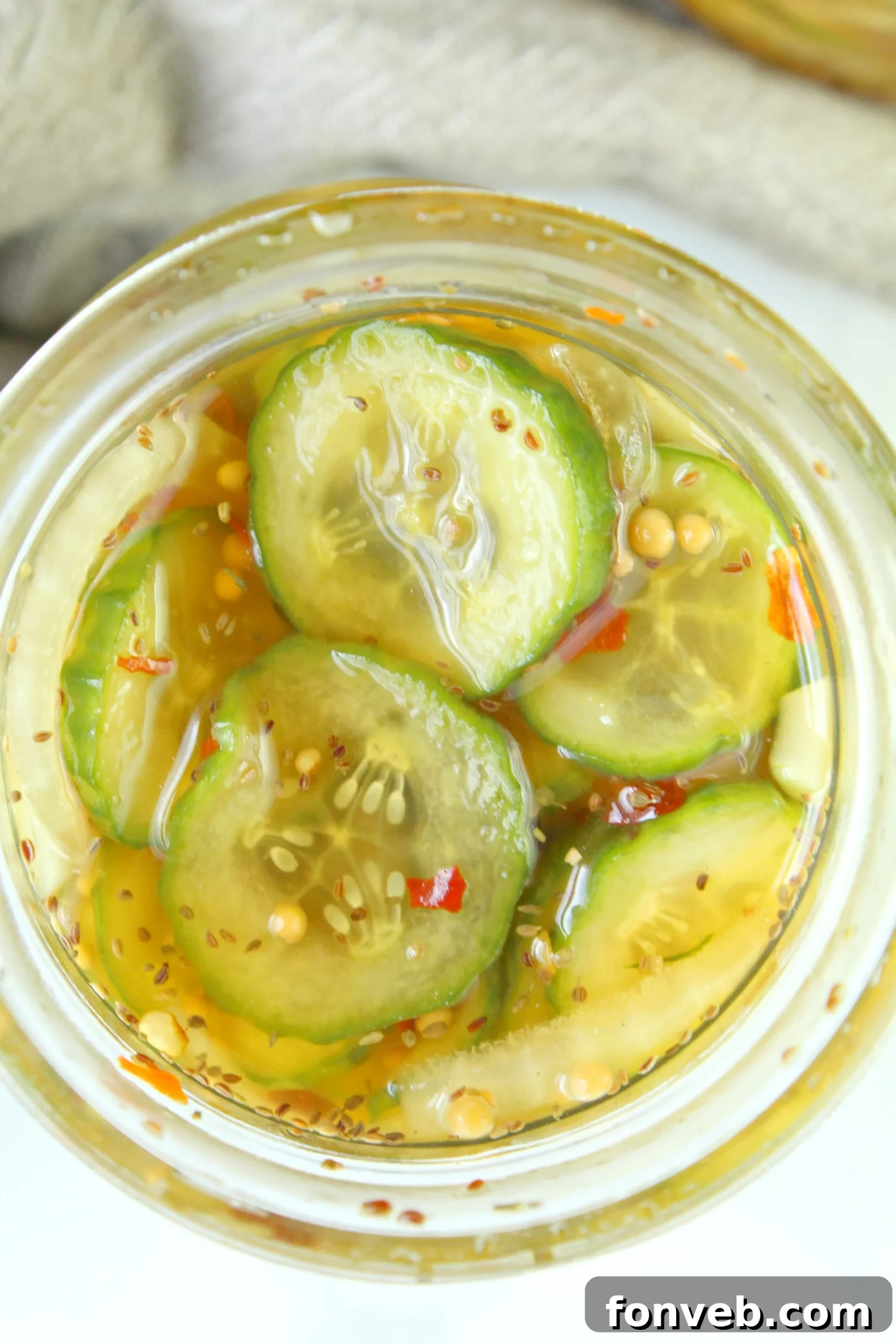 Jars of pickles in a refrigerator
