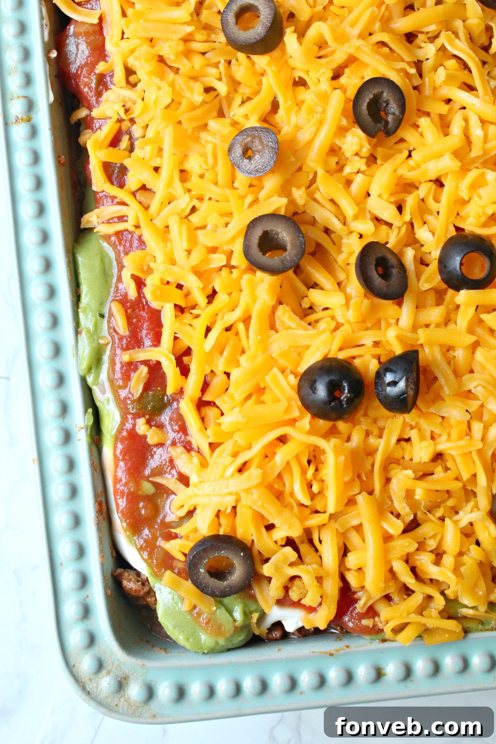 7 Layer Taco Dip 5 7 layer taco dip overhead shot in a blue baking dish