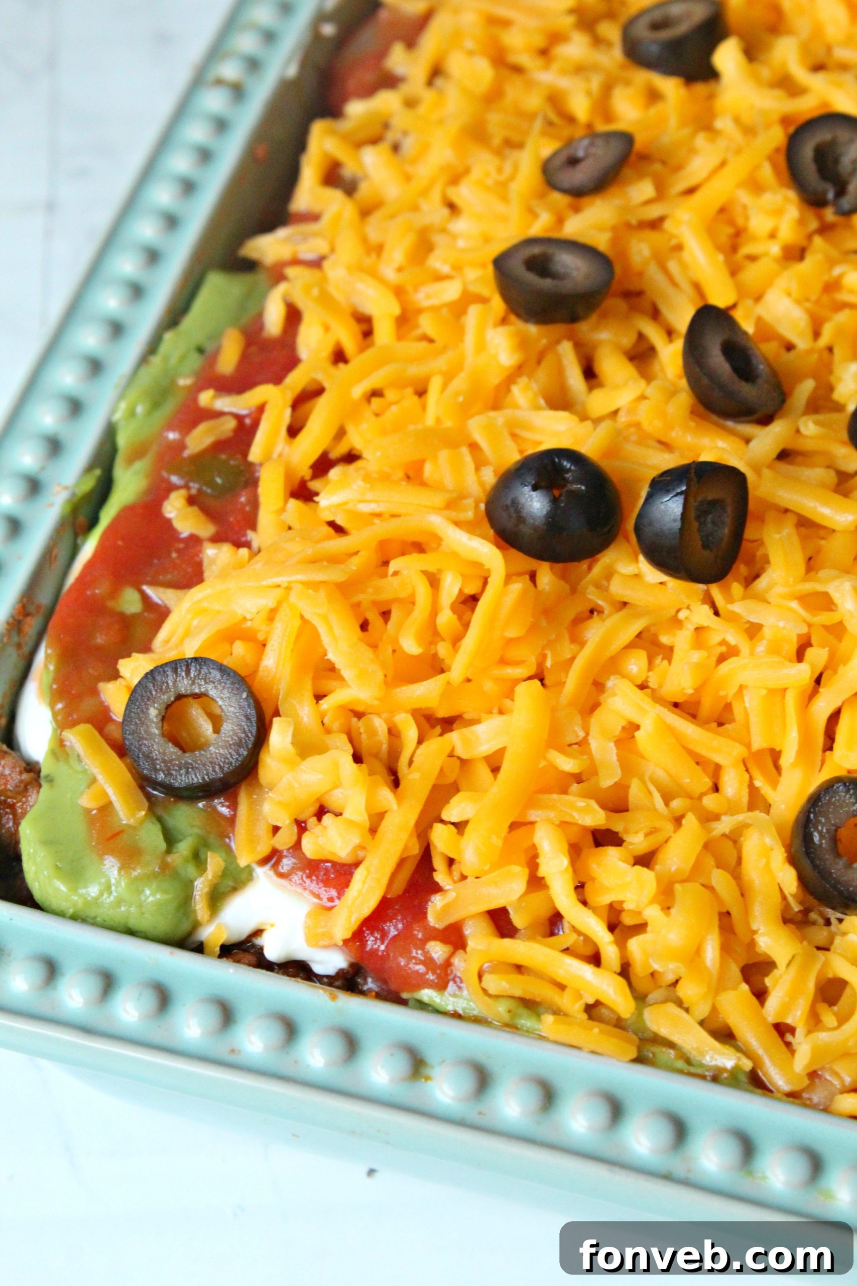 7 Layer Taco Dip 7 7 layer taco dip topped with cheese and olives close up