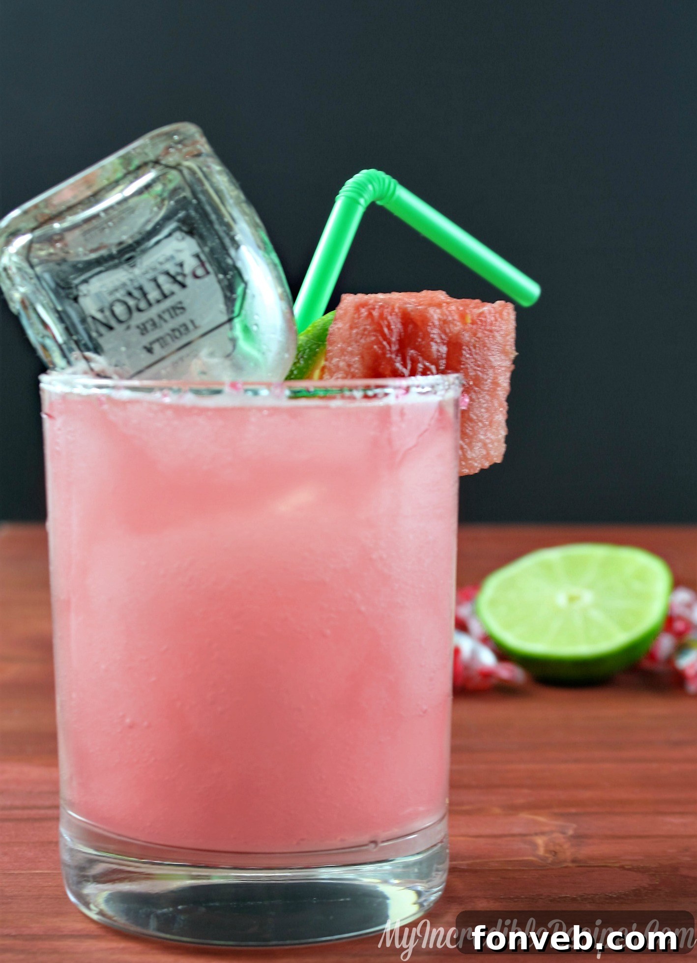 Close-up of a pink watermelon margarita with a sugar rim and a small watermelon slice garnish