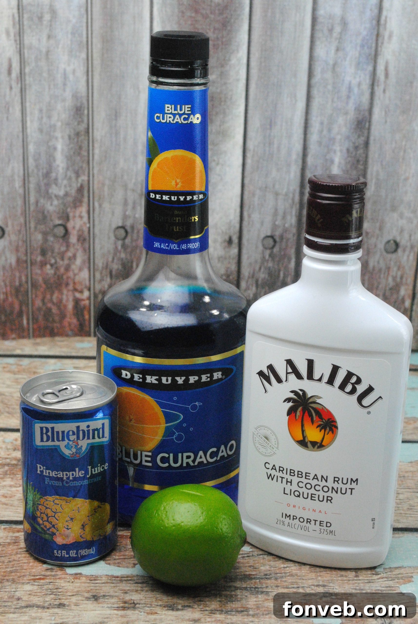 Close-up of a Shark Bite cocktail, showing vibrant blue liquid with red grenadine streaks.