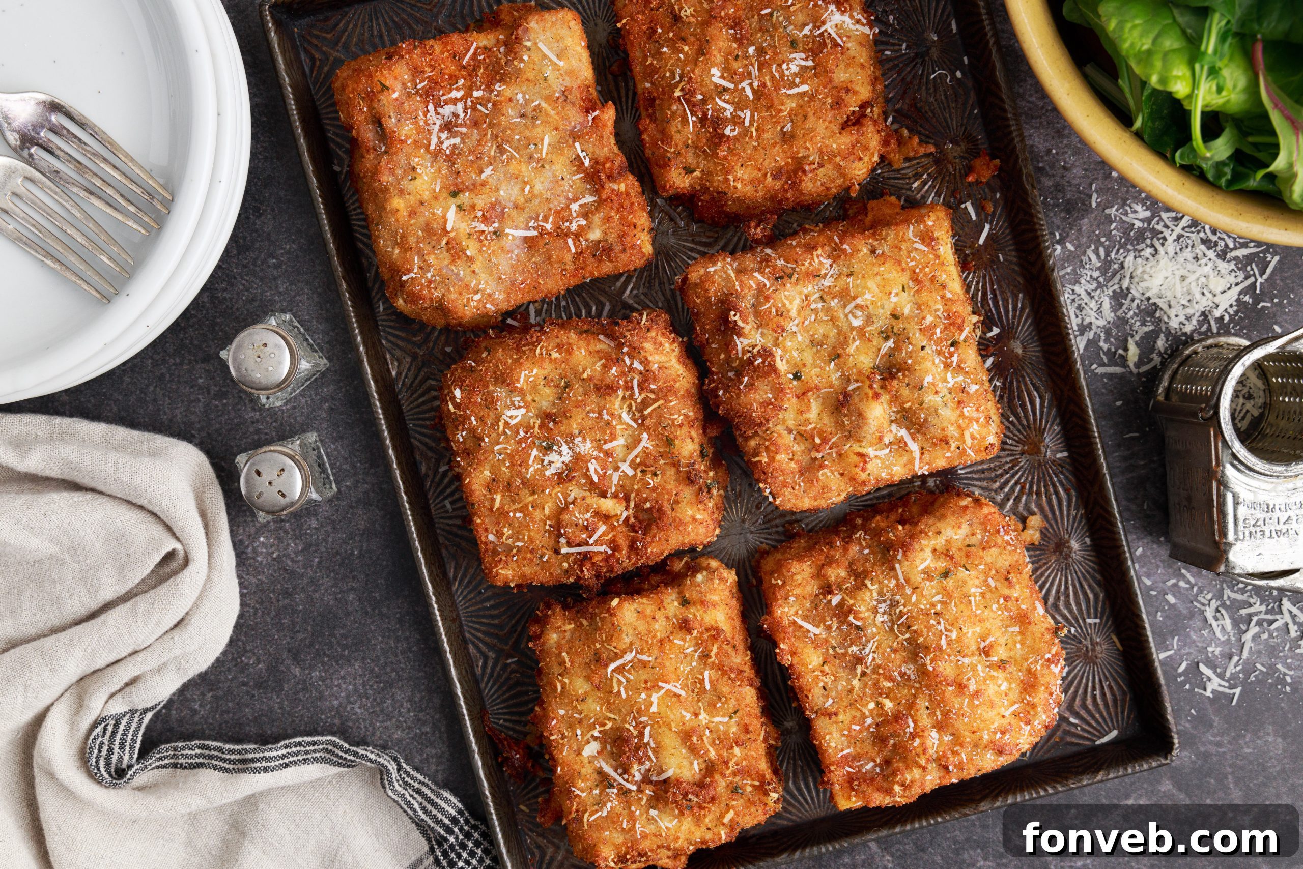 Golden Lasagna Crunch 13 Fresh parsley being sprinkled on deep fried lasagna