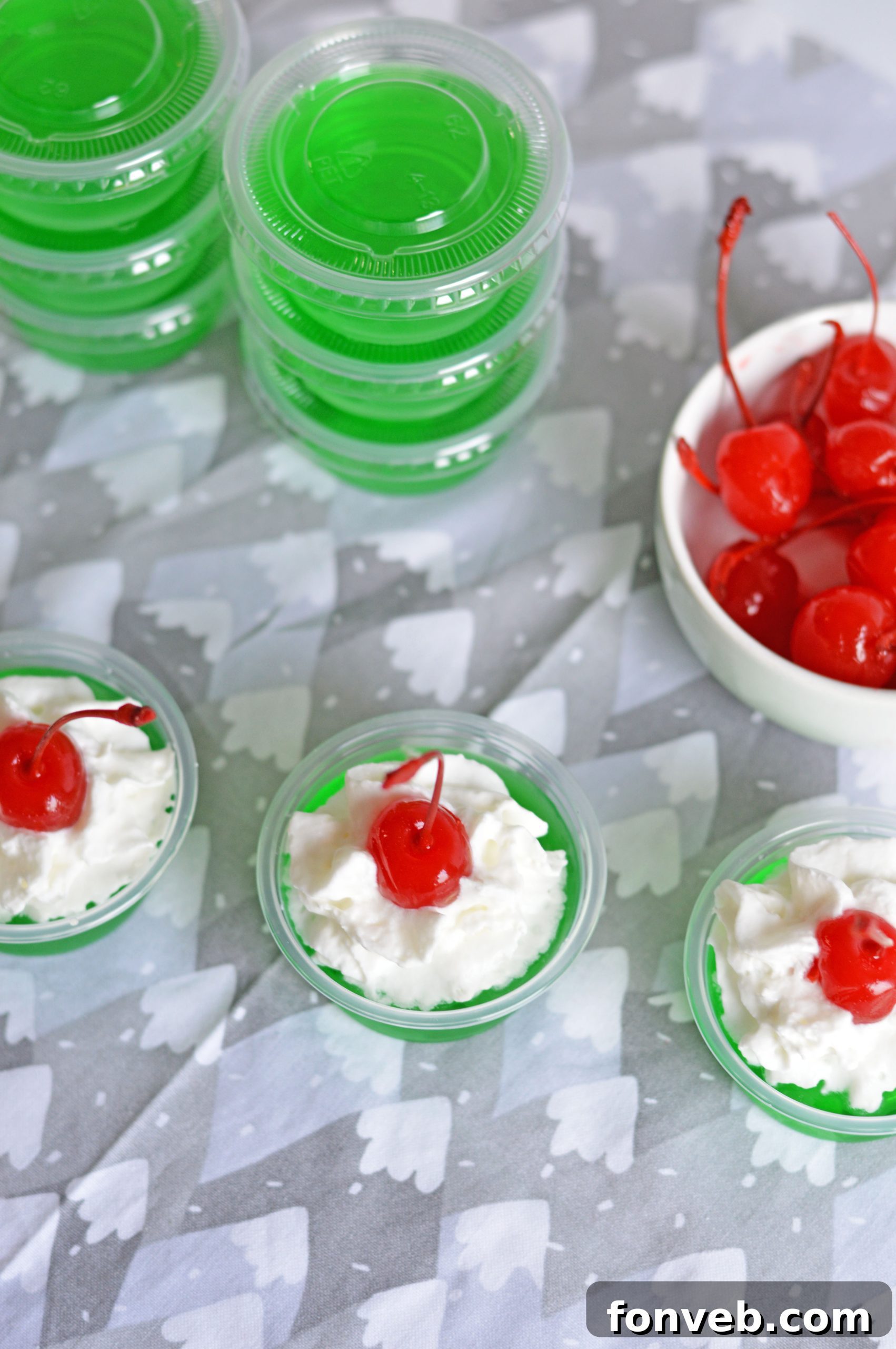 Grinch Jello Shots with focus on the red cherry 'hat'