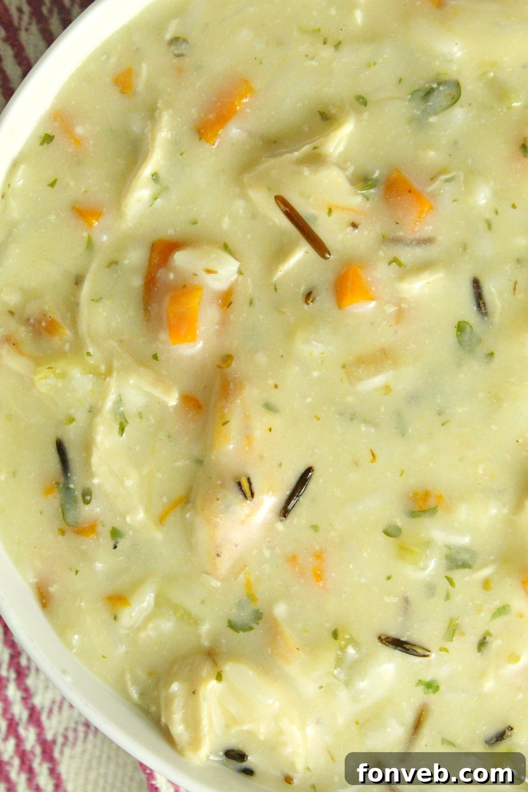 Shredded cooked chicken ready to be added to the soup.