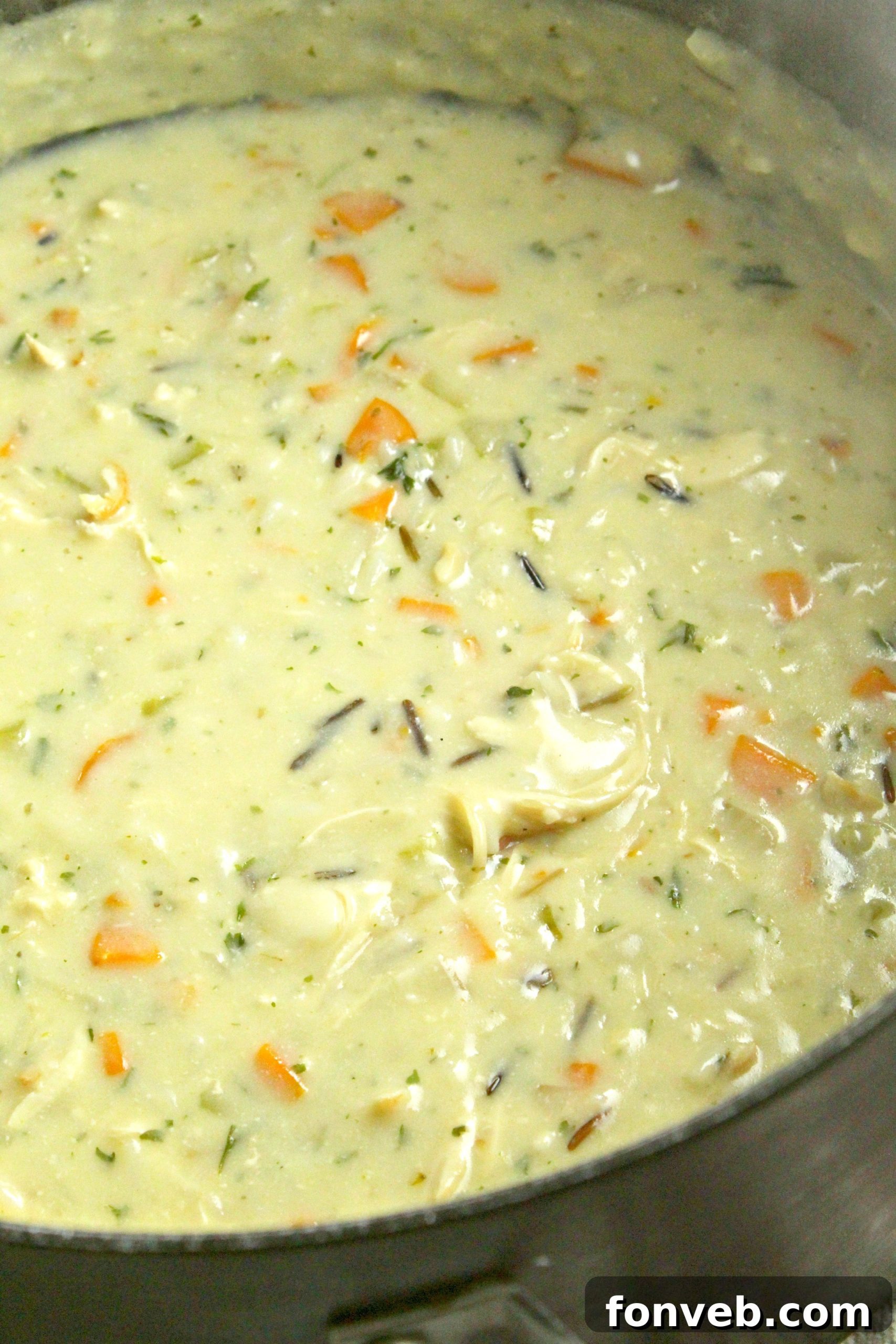 A close-up of the cooked wild rice adding texture to the soup.