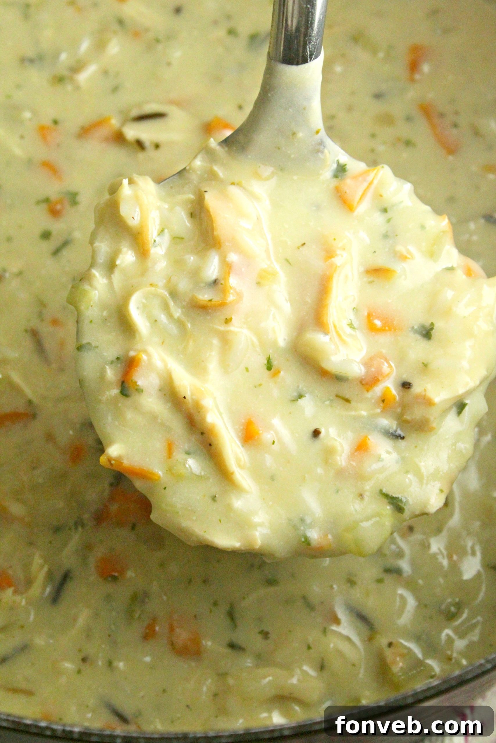 A rustic bread bowl filled with creamy chicken and wild rice soup.