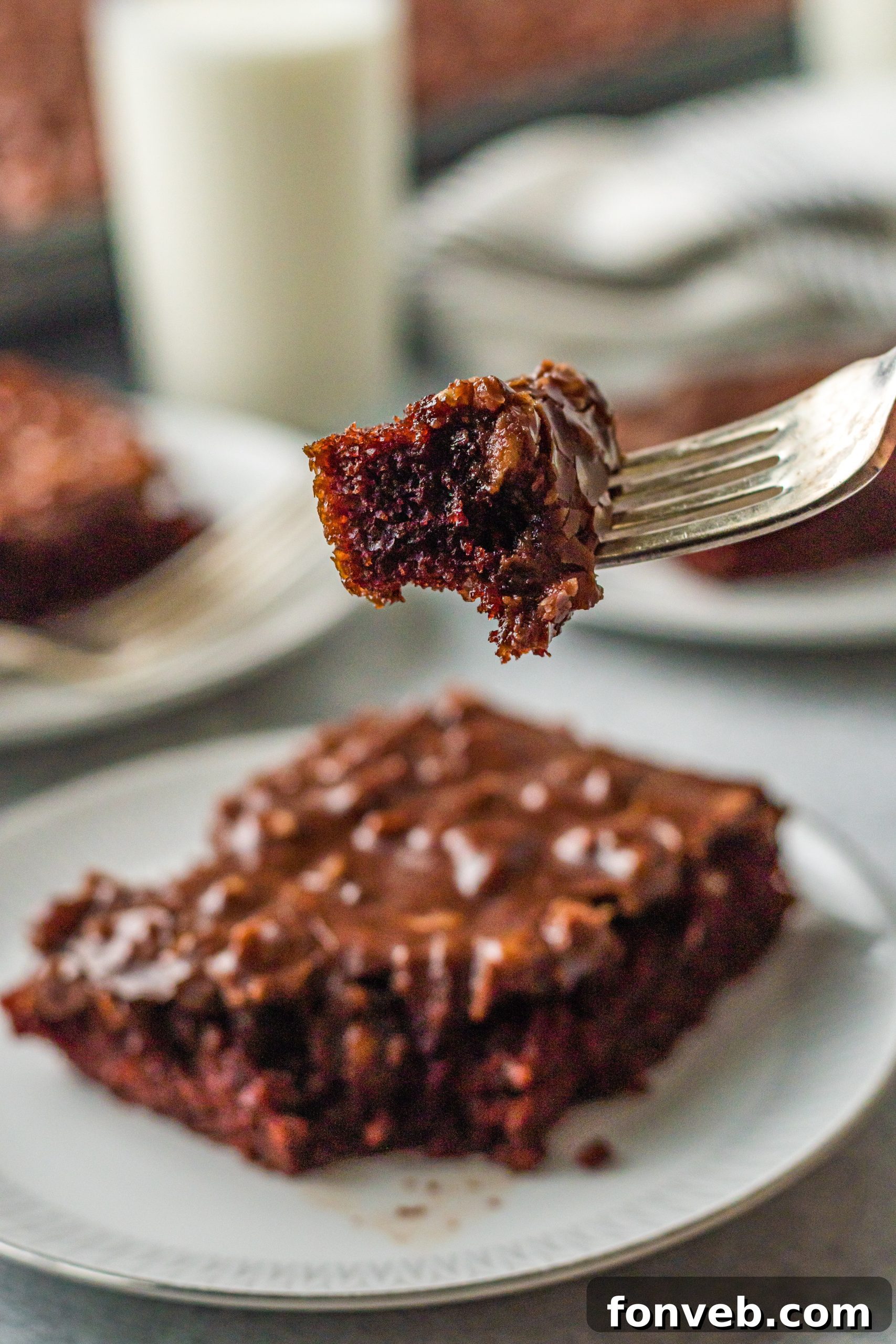 fork holding up a bite of Texas Sheet Cake 