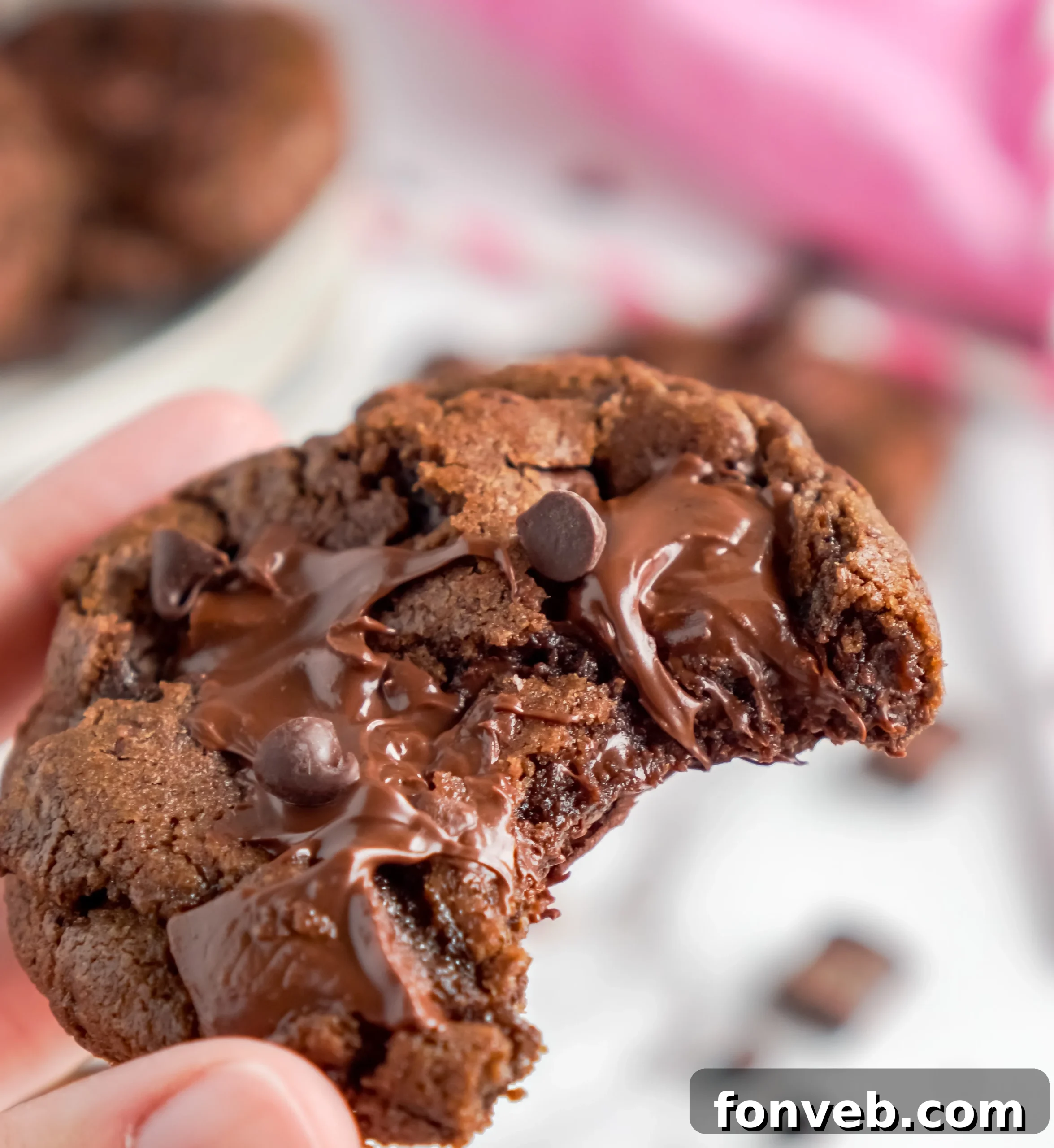 Freshly baked triple chocolate cookies on a cooling rack