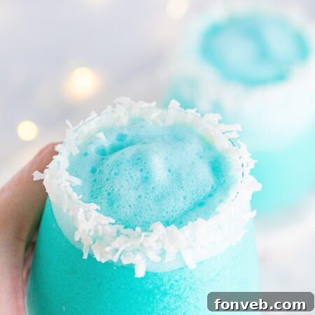 Featured image of the Jack Frost Cocktail, a beautiful blue drink with a coconut rim.