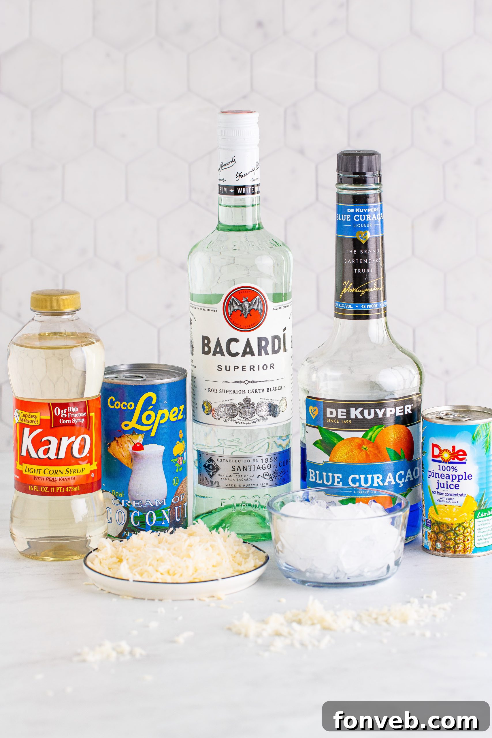 Close-up of a Jack Frost Cocktail with a glistening coconut rim, showcasing its frothy texture and vibrant blue color.