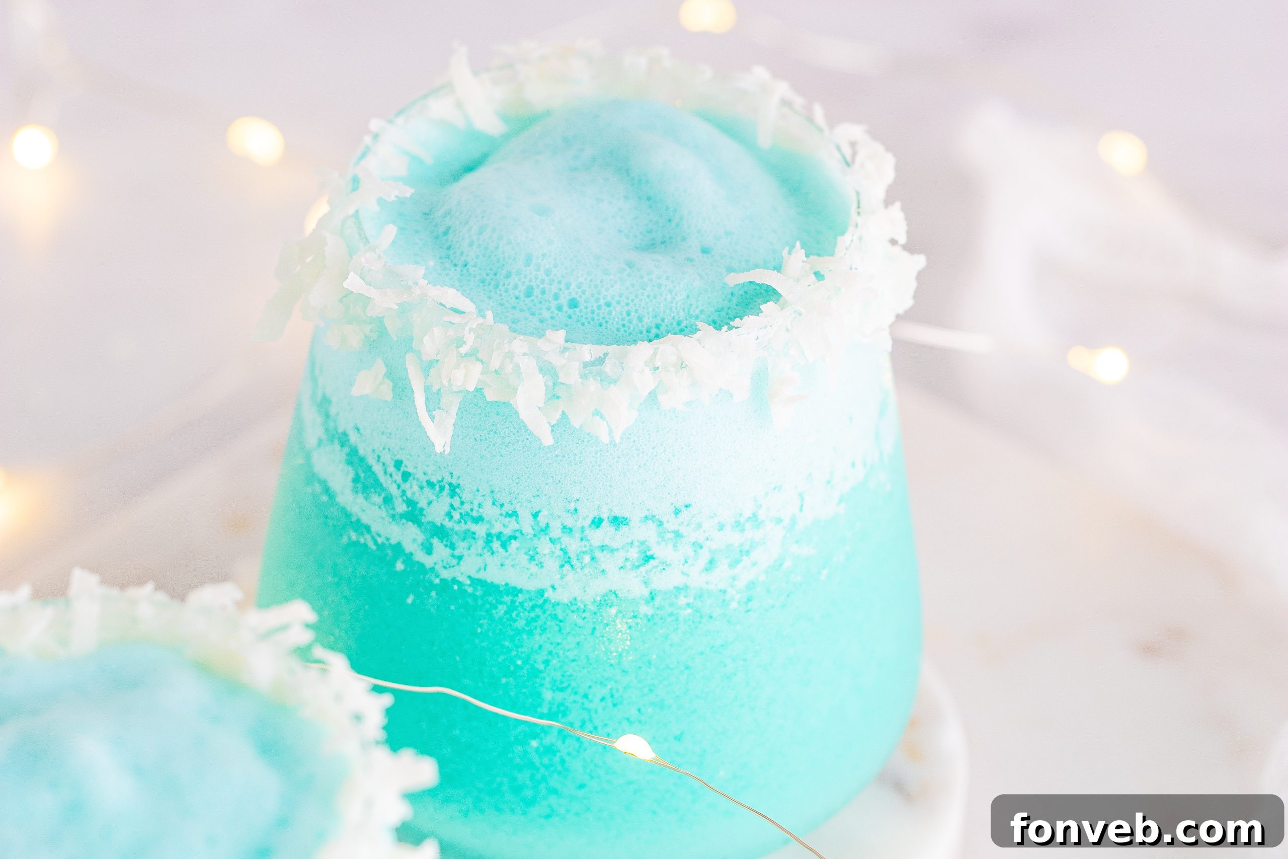 Multiple Jack Frost Cocktails in elegant glasses, showing the consistent vibrant blue color and festive garnishes.